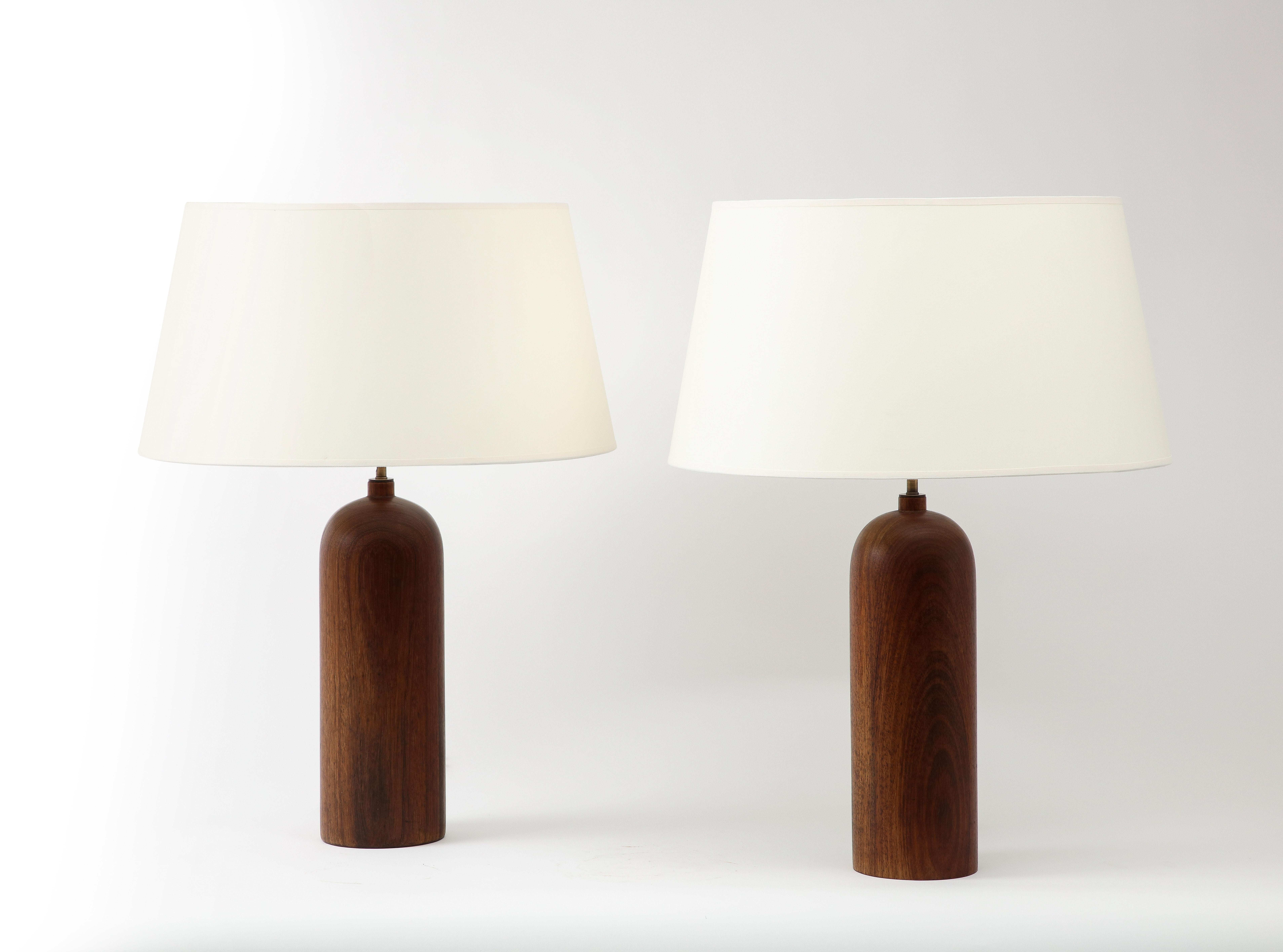 A pair of large lamps in solid Walnut. Recently rewired with brass hardware and cloth wire. Shades are available on request.