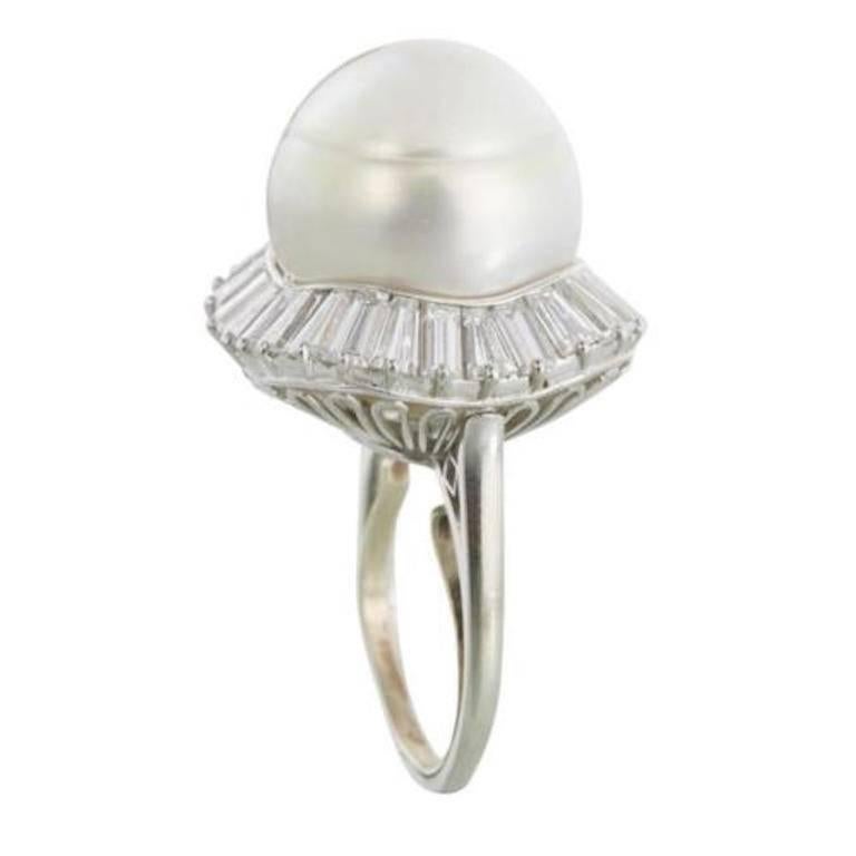 Impressive Estate Baroque South Sea Cultured Pearl 3.77 Carat VS Diamond Cocktail Ring

This stunning cocktail ring set with an approximate 17.2mm baroque South Sea pearl within a channel-set tapering baguette diamond surround; estimated total