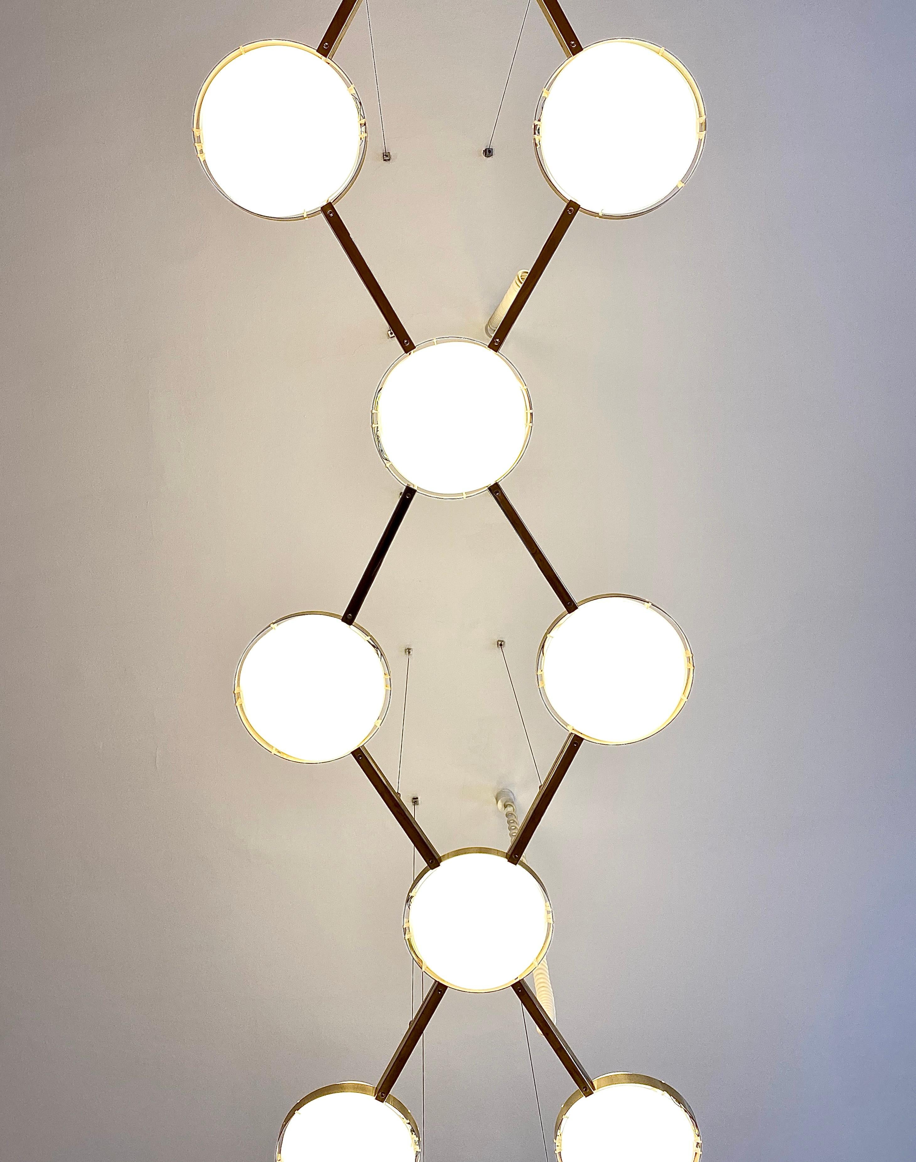 A beautiful and large Space Age ceiling lamp chandelier from the 1960s, designed and executed by Wilhelm Vest / Vest Leuchten in Austria. An impressive high-quality piece with a frame of golden anodized aluminum and ten white acrylic light diffuser