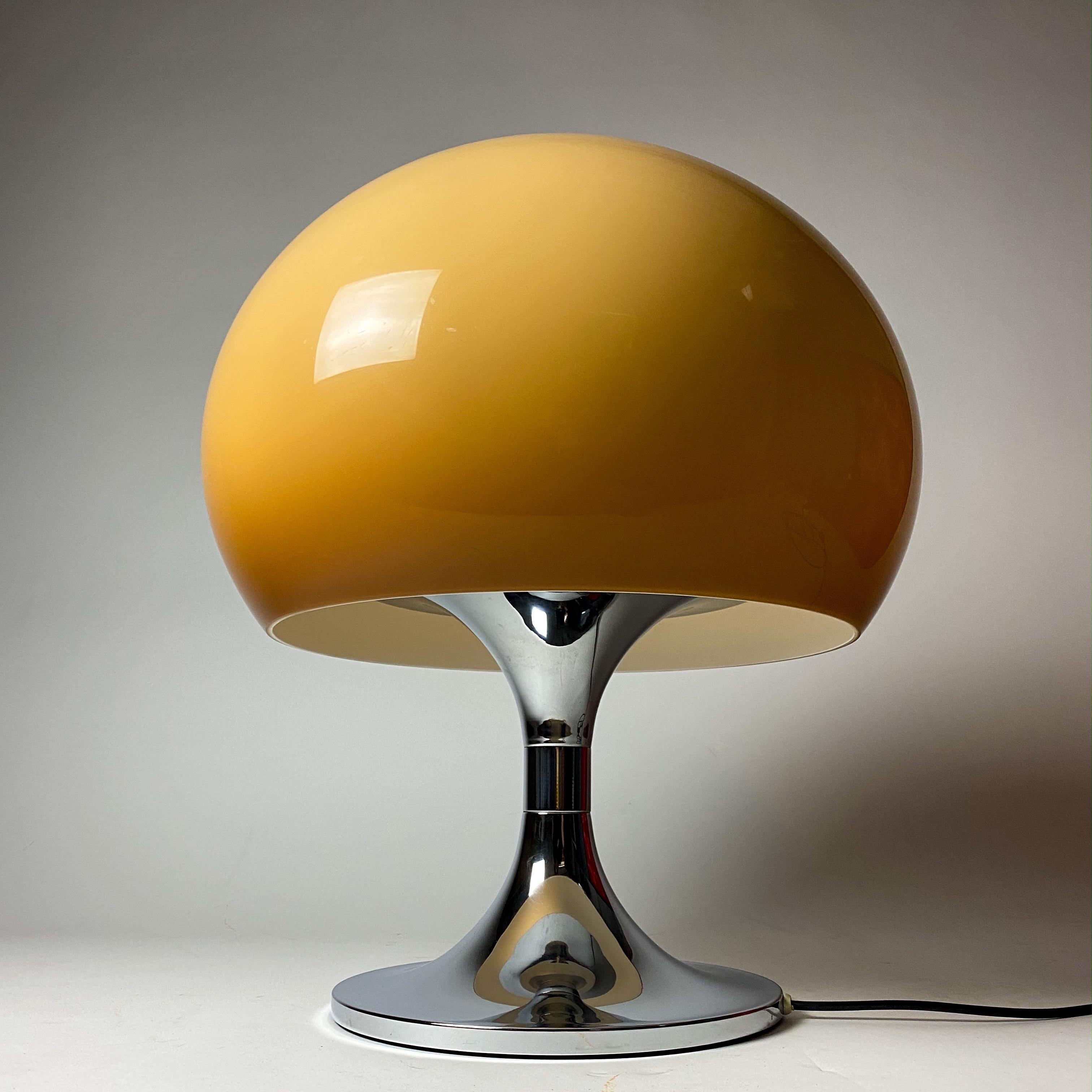 Beautiful caramel colored mushroom table lamp in style of Harvey Guzzini, Italy, 1970s.

Chrome base with a beautiful well-kept caramel colored shade. The color of the shade goes from dark brown at the bottom to light brown at the top.

This