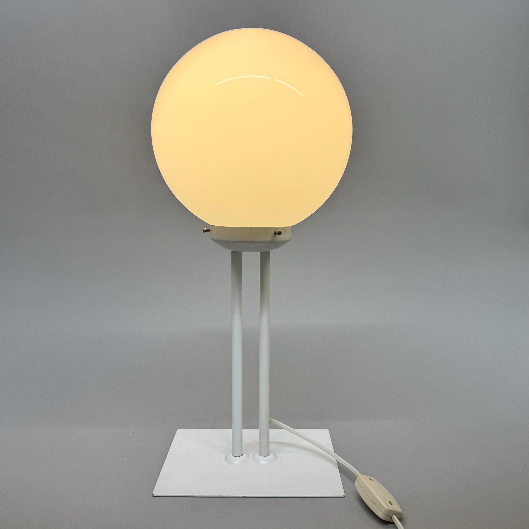 Large midcentury table lamp made in former Czechsolovakia in the 1970's. Made of metal and milk glass. The base is 23.5 cm wide and 17.5 cm deep. Original, fully functional wiring. Bulbs: 1 x E26 (E27). US adapter included.