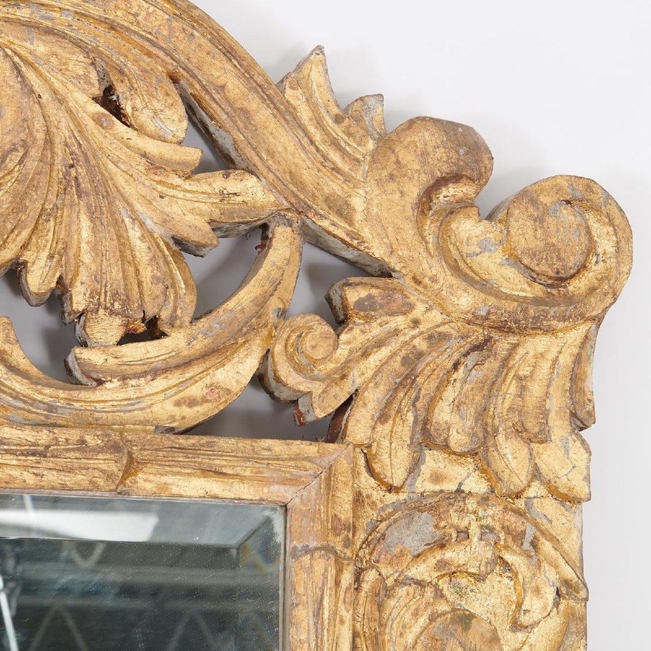 Spanish Baroque style carved wood framed mirror with gold wash finish surrounding a beveled edged mirror center.
Can be used as a floor mirror or hung on the wall.