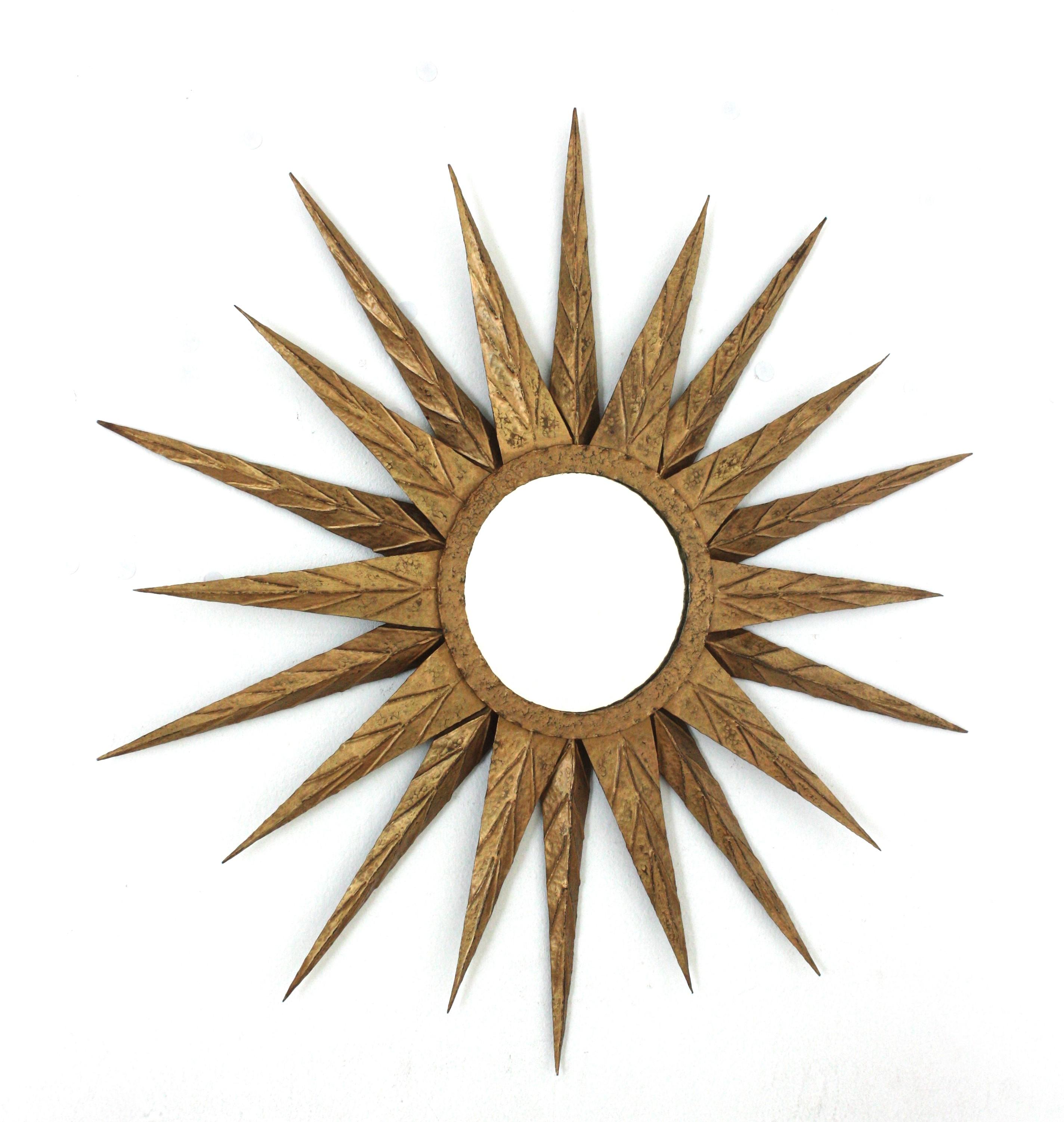Brutalist Starburst Sunburst Wall Mirror, Wrought Gilt Iron, Spain, 1950s
The frame is entirely made by hand. Finished in gold leaf. Gorgeous gilding and terrific patina.
This starburst mirror was manufactured at the Mid-Century Modern period and