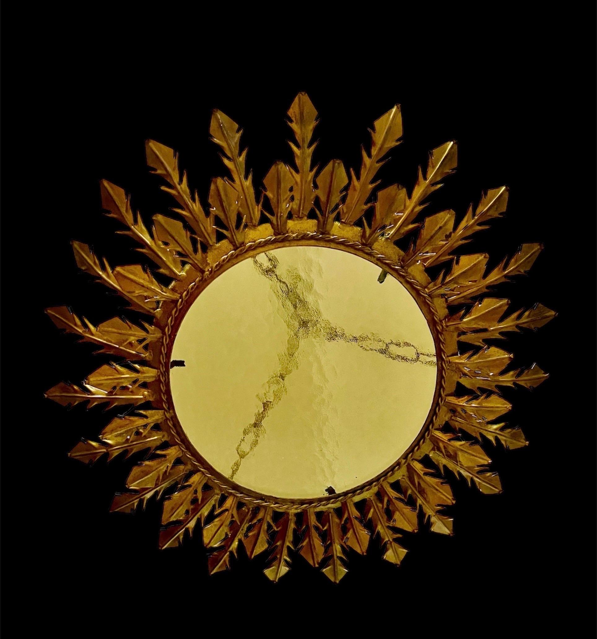 Large Spanish crown light in gilt metal and frosted glass, Spain, 1950s. Midcentury antique gilt iron frame or pendant with laurel leaf motifs surrounding a central frosted glass diffuser. Handcrafted in hammered iron with gold leaf finish. Superb