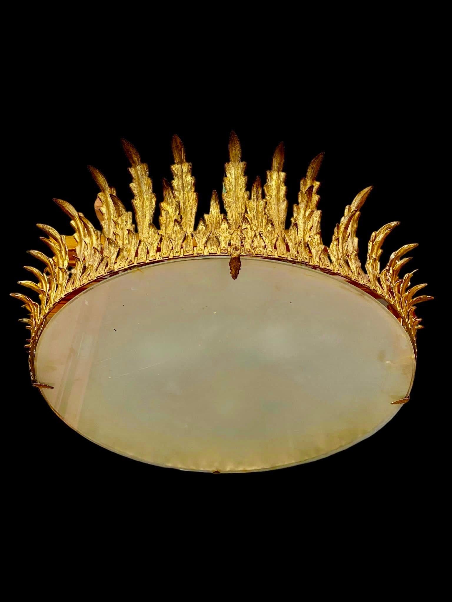 Large Spanish crown light in gilt metal and frosted glass, Spain, 1950s. Mid-century antique gilt iron frame or pendant with laurel leaf motifs surrounding a central frosted glass diffuser. Handcrafted in hammered iron with gold leaf finish. Superb