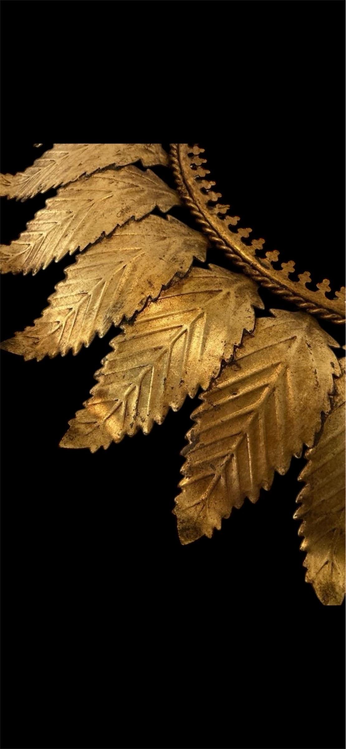 Large Spanish sunburst light in gilt metal and frosted glass ; white ; opaline
 Spain, 1950s. Midcentury antique gilt iron frame or pendant with laurel leaf motifs surrounding a central frosted glass diffuser. Handcrafted in hammered iron with gold
