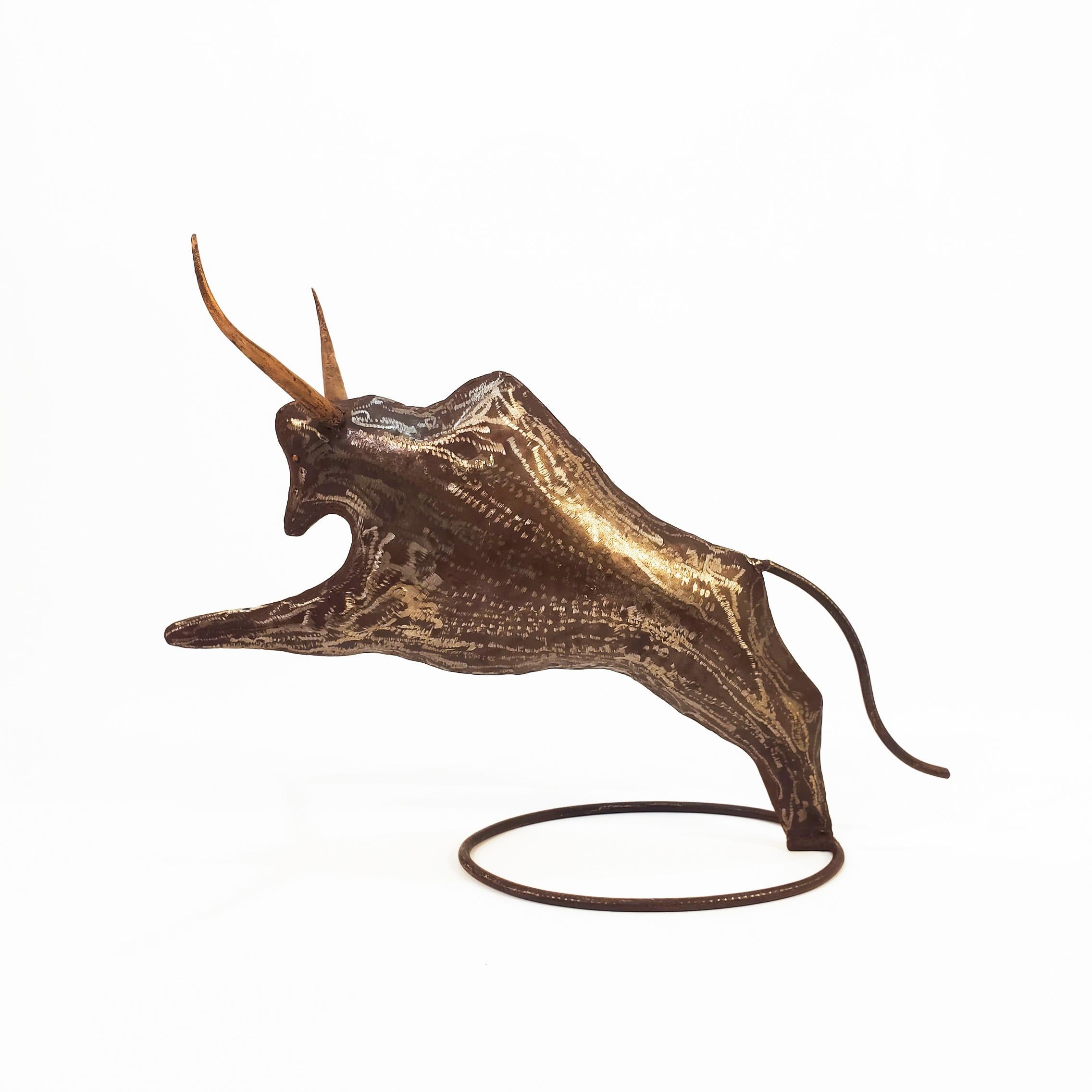 Pair of large Spanish sculptures depicting two buffaloes in brutalist style, circa 1955. Made of patinated and aged wrought iron metal, with polychromed horns and eyes in gold leaf. Light weight, and attached to an oval base of the same metal. Very