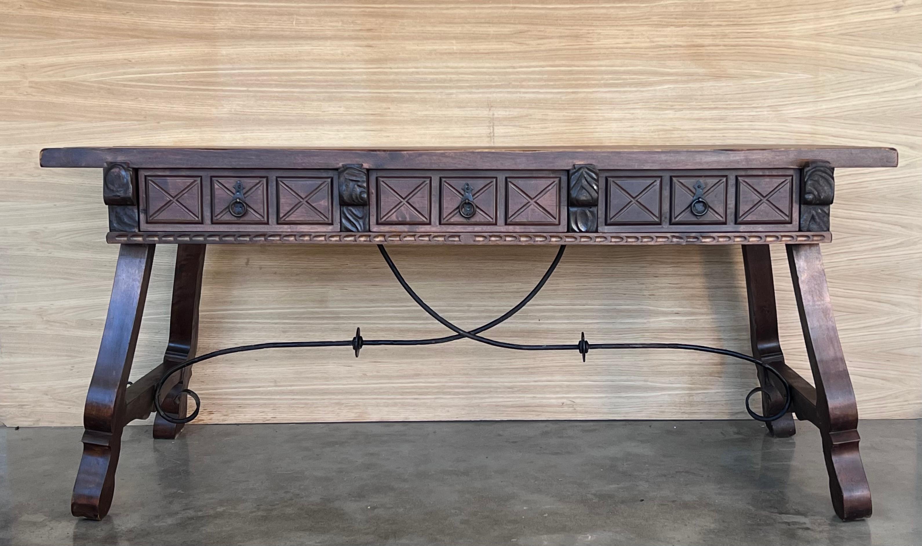 Handsome walnut library piece that can be used as a desk or Work table. Made of walnut having carved gadrooned and lyre legs and a stretcher made of iron. Carved on all sides .
 19th century.


