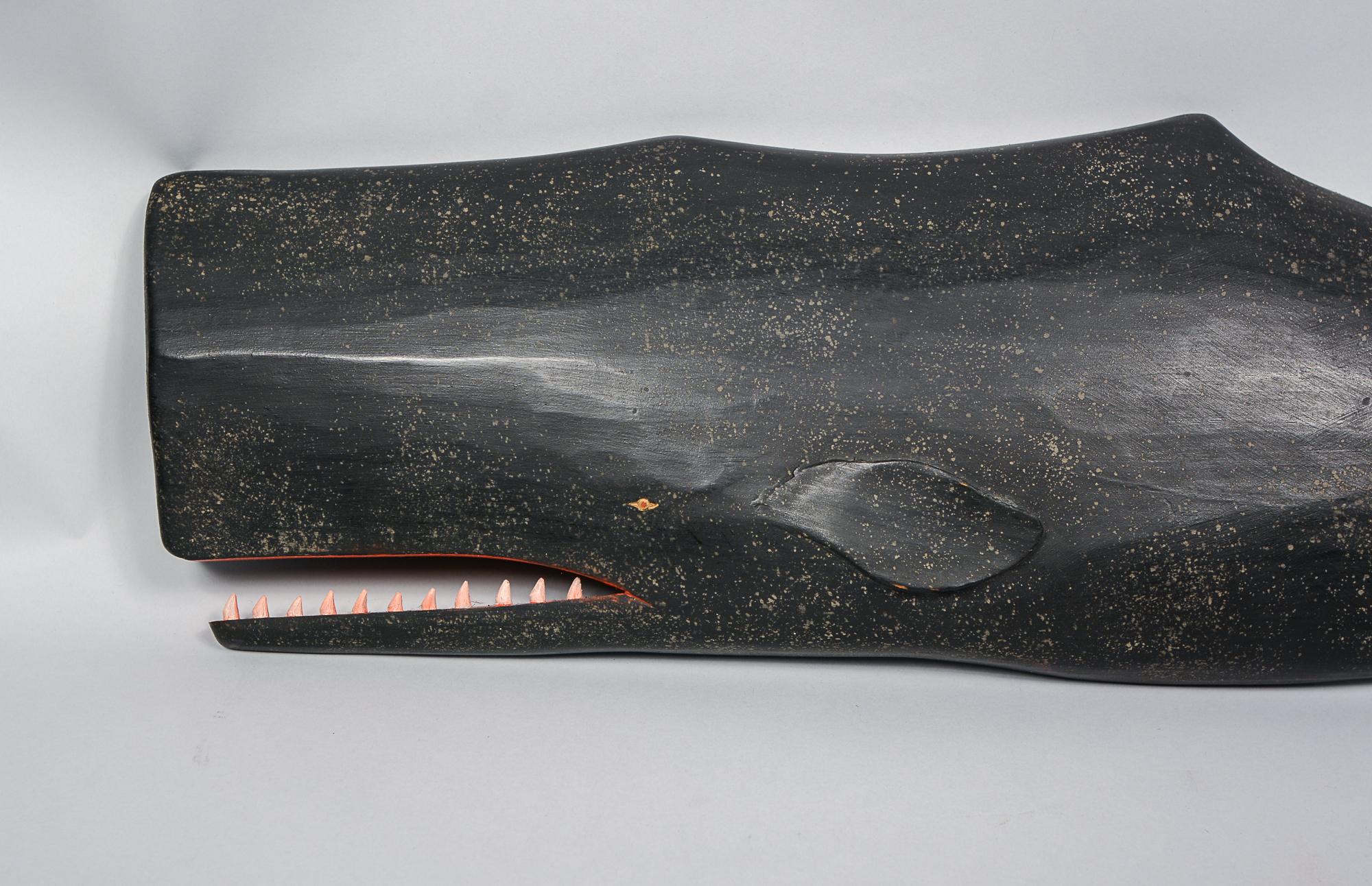 Large size sperm whale wall plaque by Clark Voorhees. This carving is just under three feet long. The whale is signed on the back with the artist's monogram and name.  The lower jaw shows a glue line. I have seen this described as a repair but this