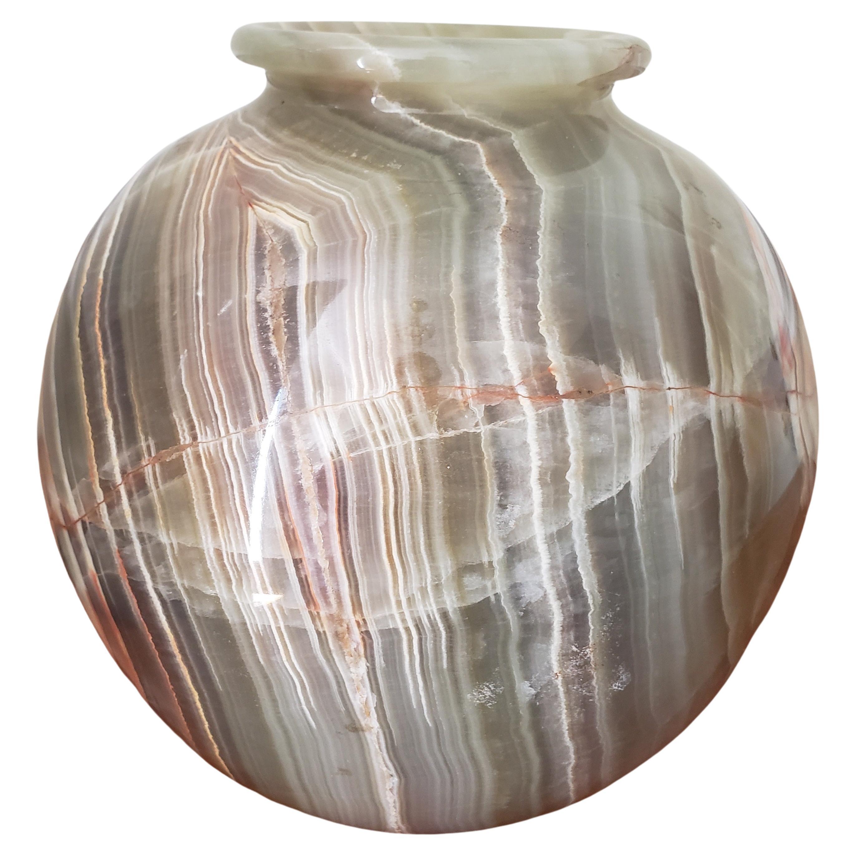 Mid-Century Modern vase carved from a single block of highly figured onyx marble. Primarily rich gray emerald colour with hundreds of alternating veins, some of white and some of red. Appropriate for multiple decor styles.
Measures 10