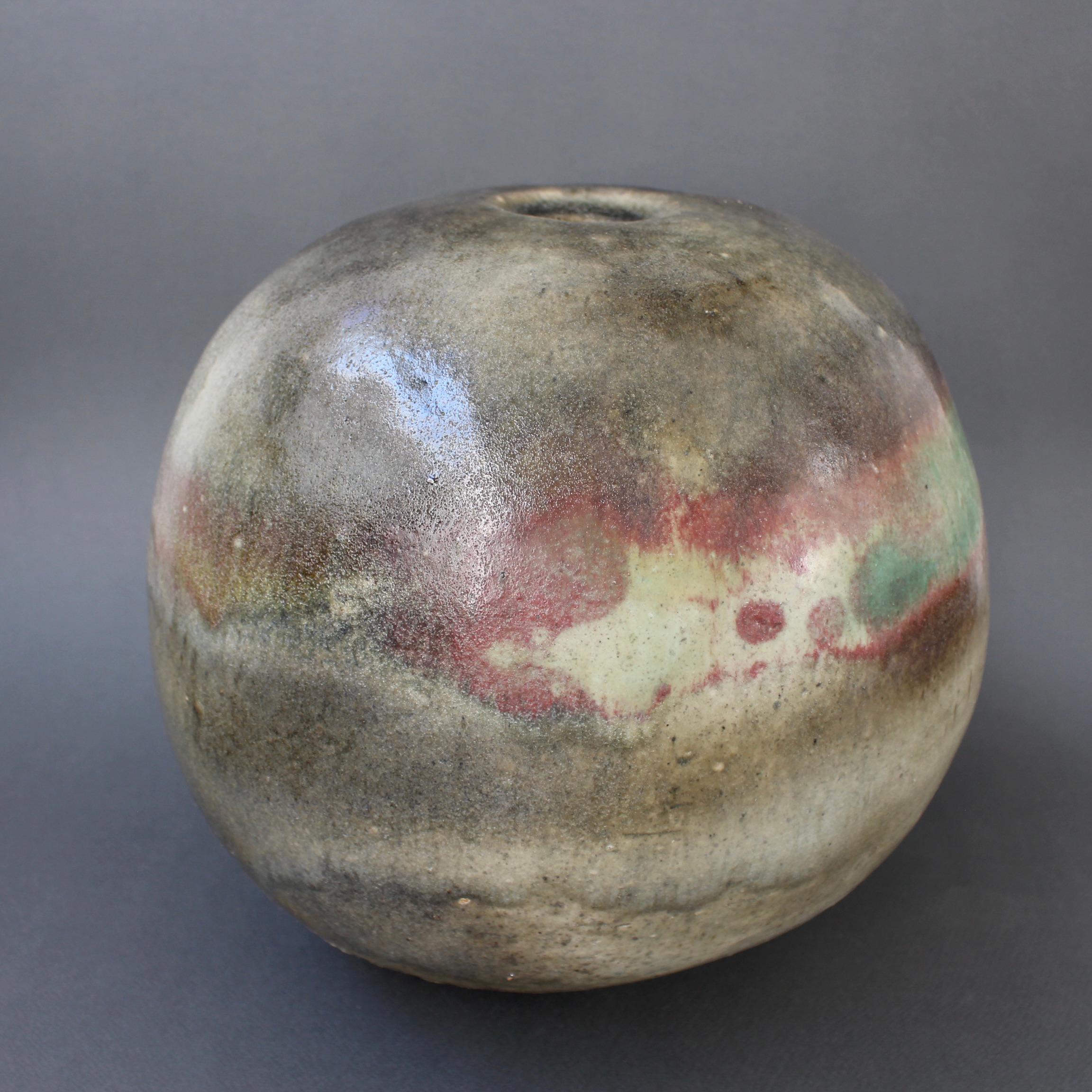 Large spherical stoneware vase by Ingeborg and Bruno Asshoff (circa 1960s). A multi-hued overflow glaze with mulberry and turquoise sections over olive, ochre and hazy grey with a very textured feel. The large spherical shape surprises with the