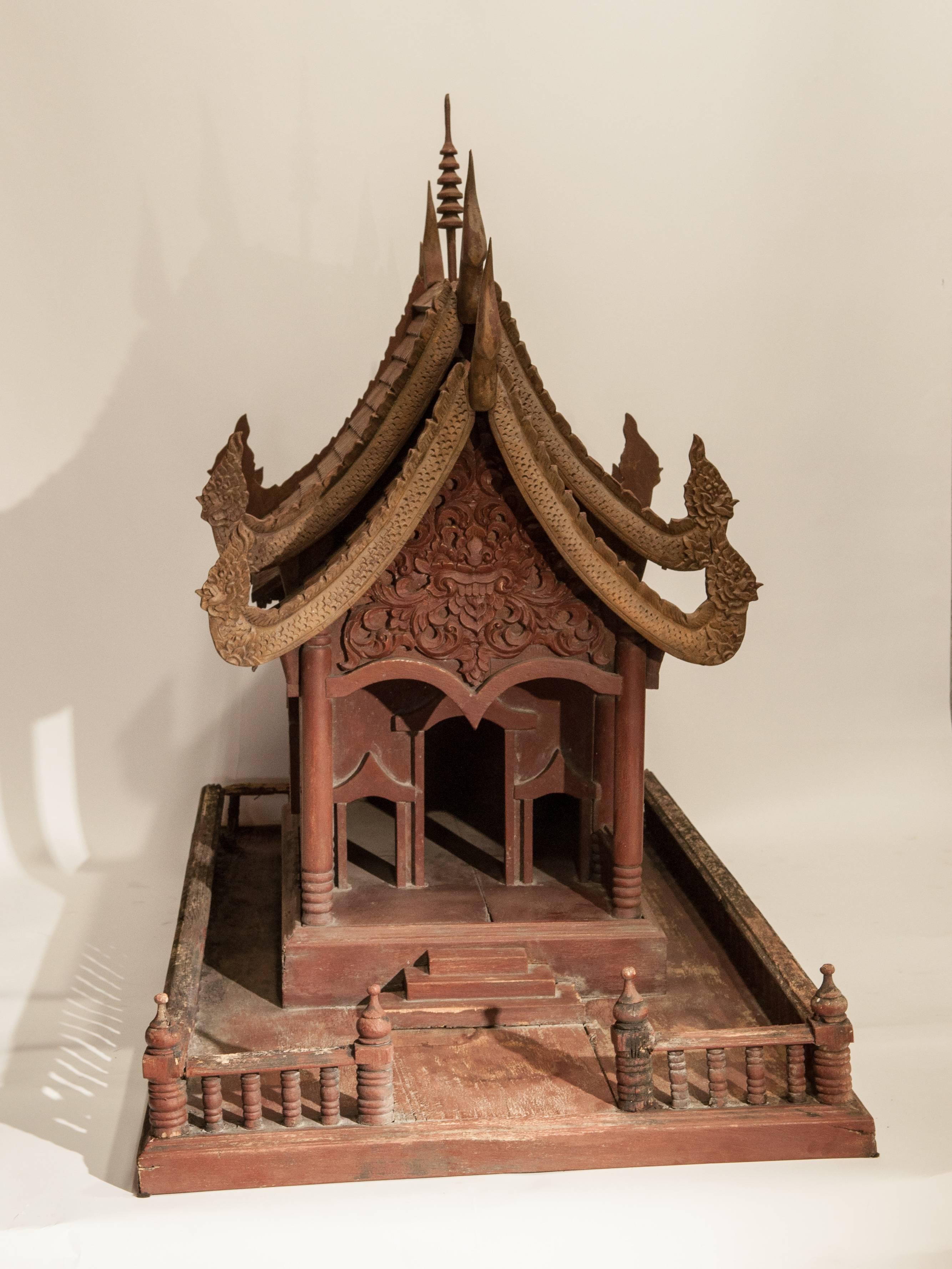 Large spirit house from Northern Thailand, teak, mid-20th century.
Offered by Bruce Hughes.
This large spirit house models a large scale Thai Buddhist temple, and incorporates a range of traditional architectural details -- the roof finial called