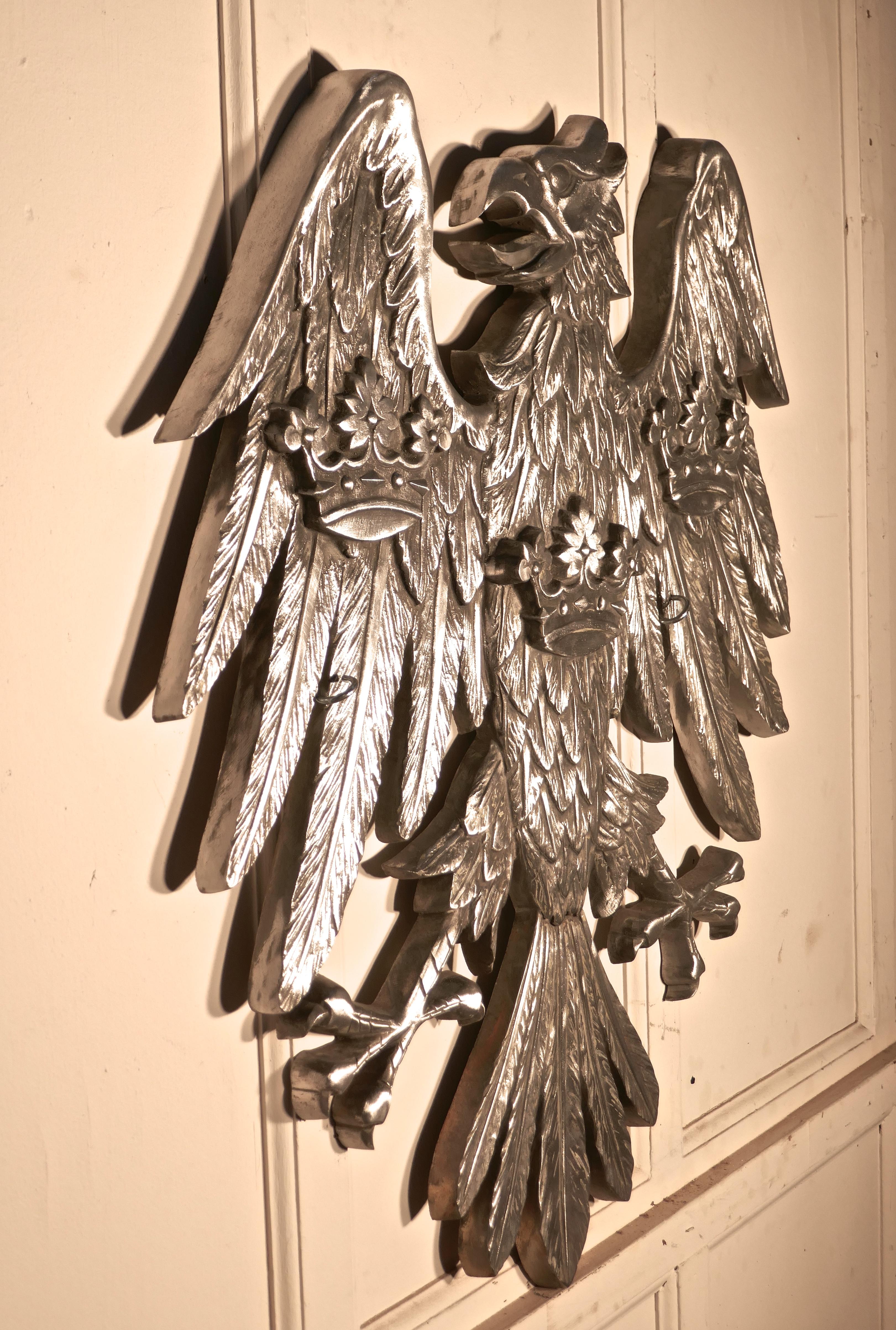 Large spread eagle wall plaque, Heraldic trade sign

This is a very large piece, it is made in polished silver metal, the plaque would have been displayed by the Barclays Bank company
Our giant eagle has 3 crowns cast on its feathers, it is in