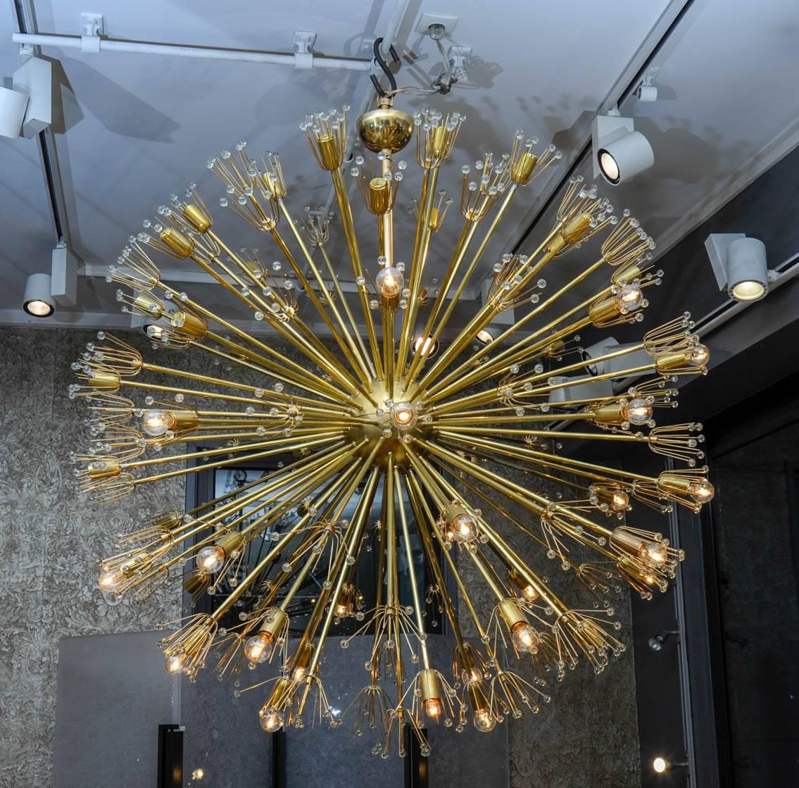 This large chandelier is an original creation by Studio Glustin. Picks are made of brass and Murano glass, 52 lights are composing it.