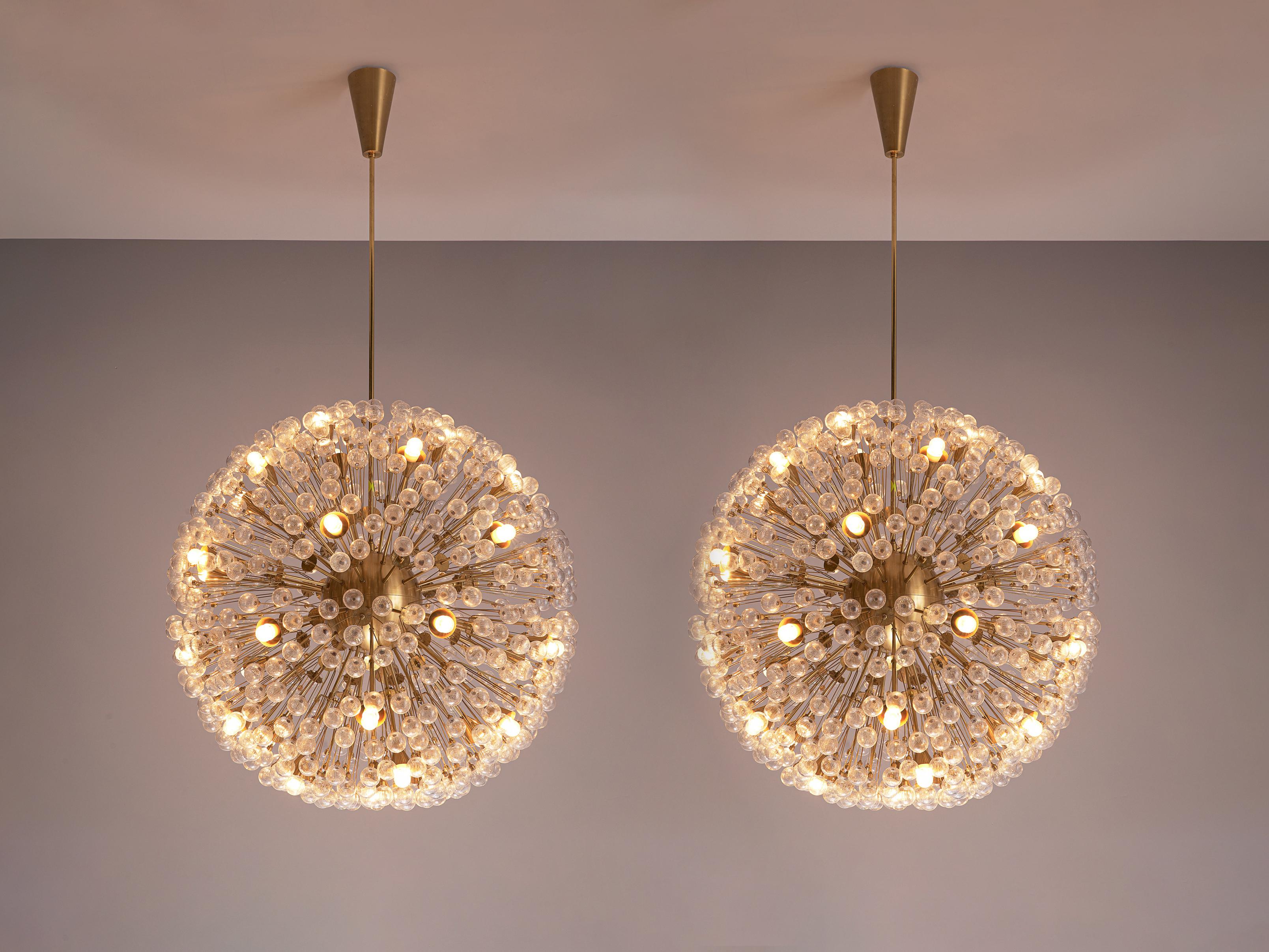 'Sputnik' chandeliers, brass, glass, Austria, 1960s

Beautiful and sizeable 'Sputnik' chandelier made in Austria in the 1960s. This light consist of a center sphere from which many rods with glass spheres at each end are held. The small spheres are