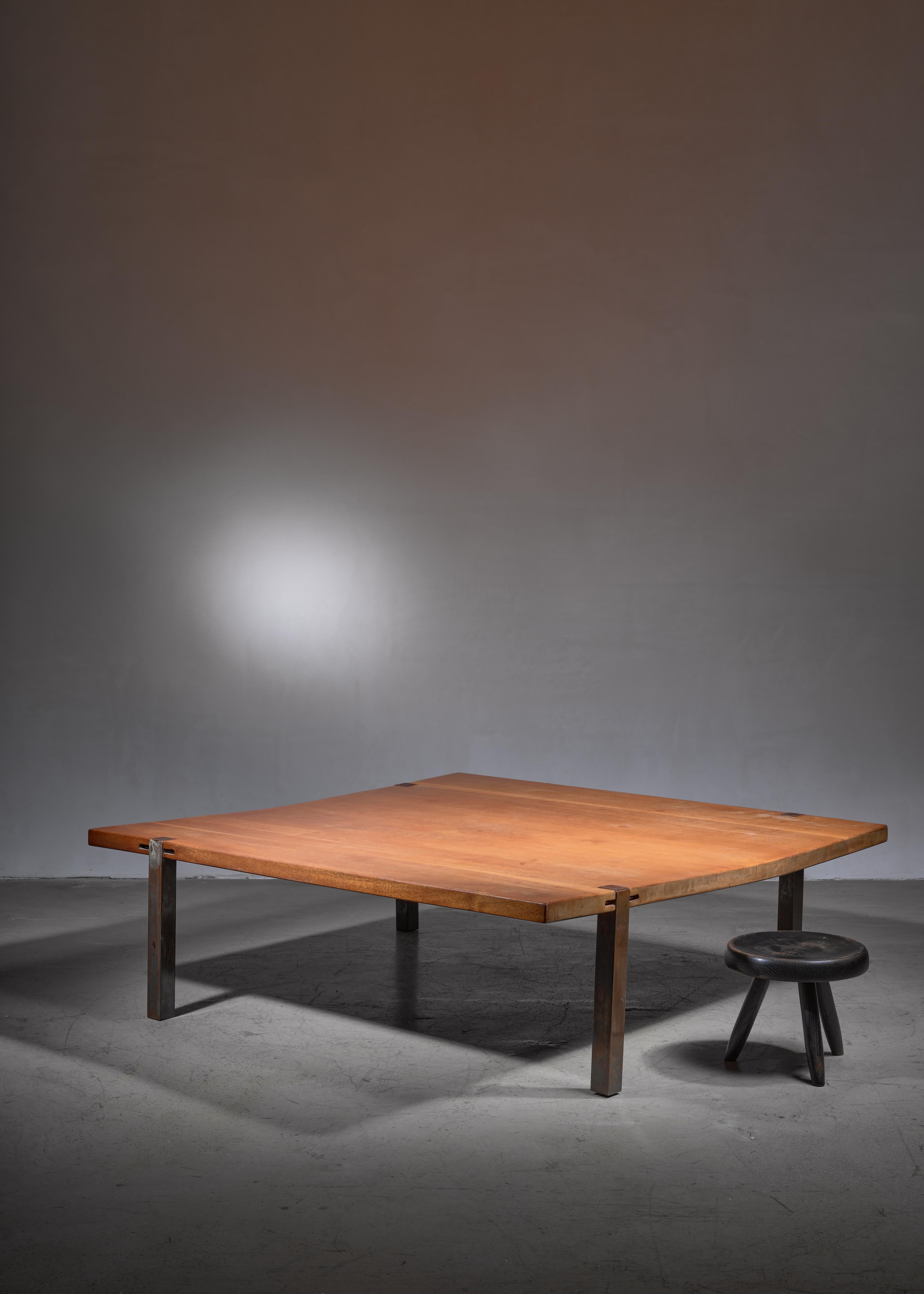 A very large square coffee table by an unknown Danish cabinetmaker. The table is made of a solid teak top, standing on four copper plated steel legs.
The top is sunbleached, giving the top an oak like appearance. The solid top is slightly bent