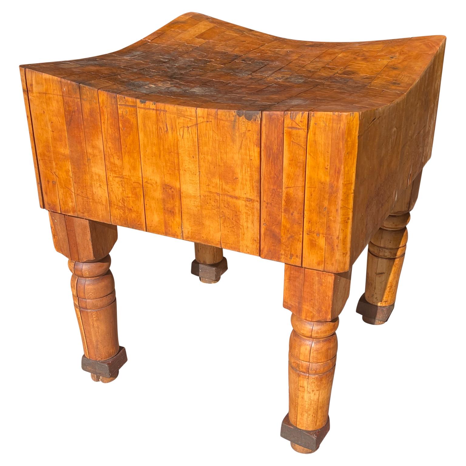 Large Mid-Century Modern large butcher block. This incredible butcher block has a beautiful aged patina. The aged maple wood is glowing with it's history of use and character. The tall sturdy legs and undulated surface make this piece a work of