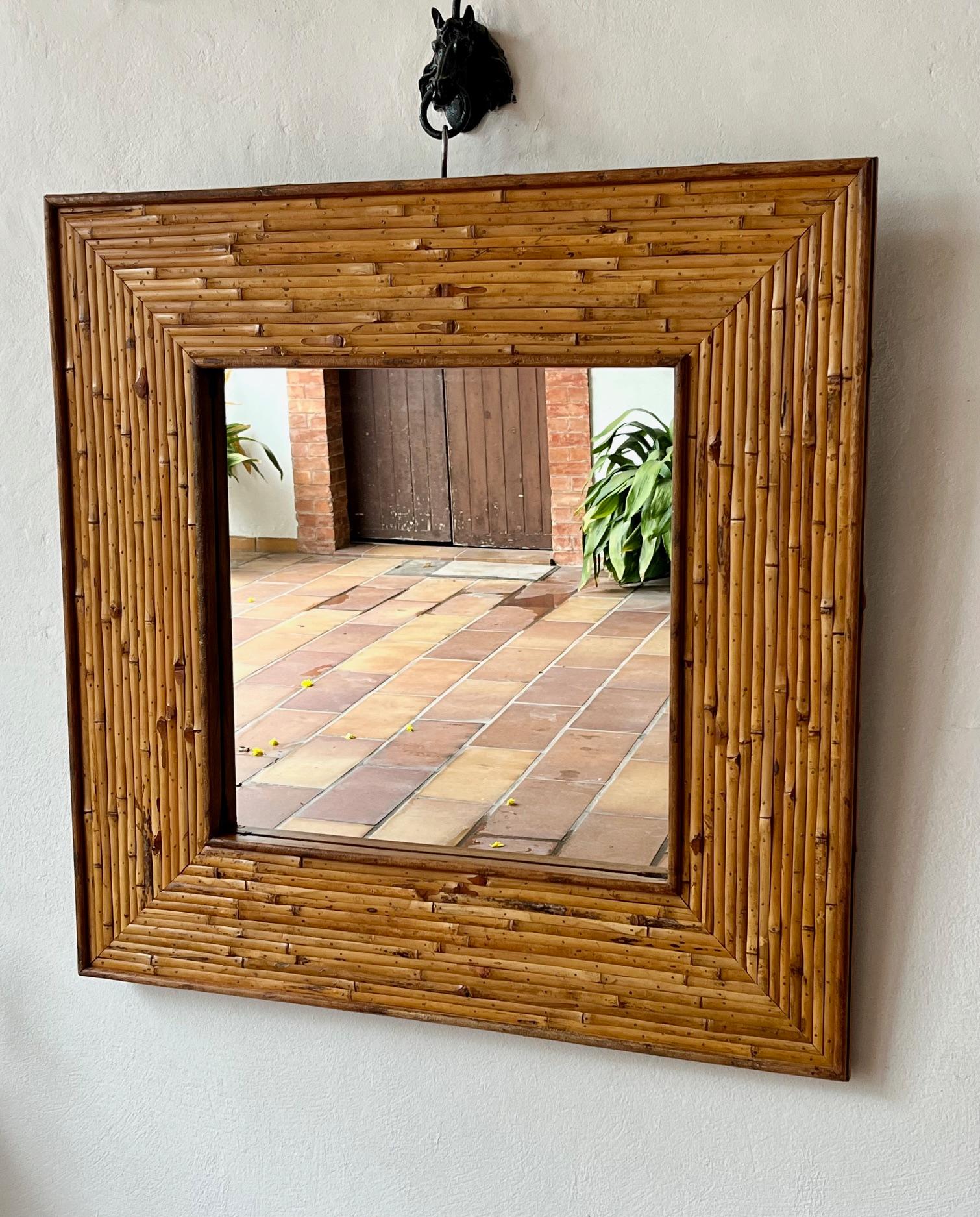 Large square mirror. 
The wide frame is veneered with bamboo. Frame width: 21 cm, 8.3 inches 
Very strong build on an oak frame
France, probably French Riviera ( Côte d'Azur ) 
Circa 1960.  


H: 100 cm ( 39.4 inches) 
W: 100 cm ( 39.4 inches) 
D: 4