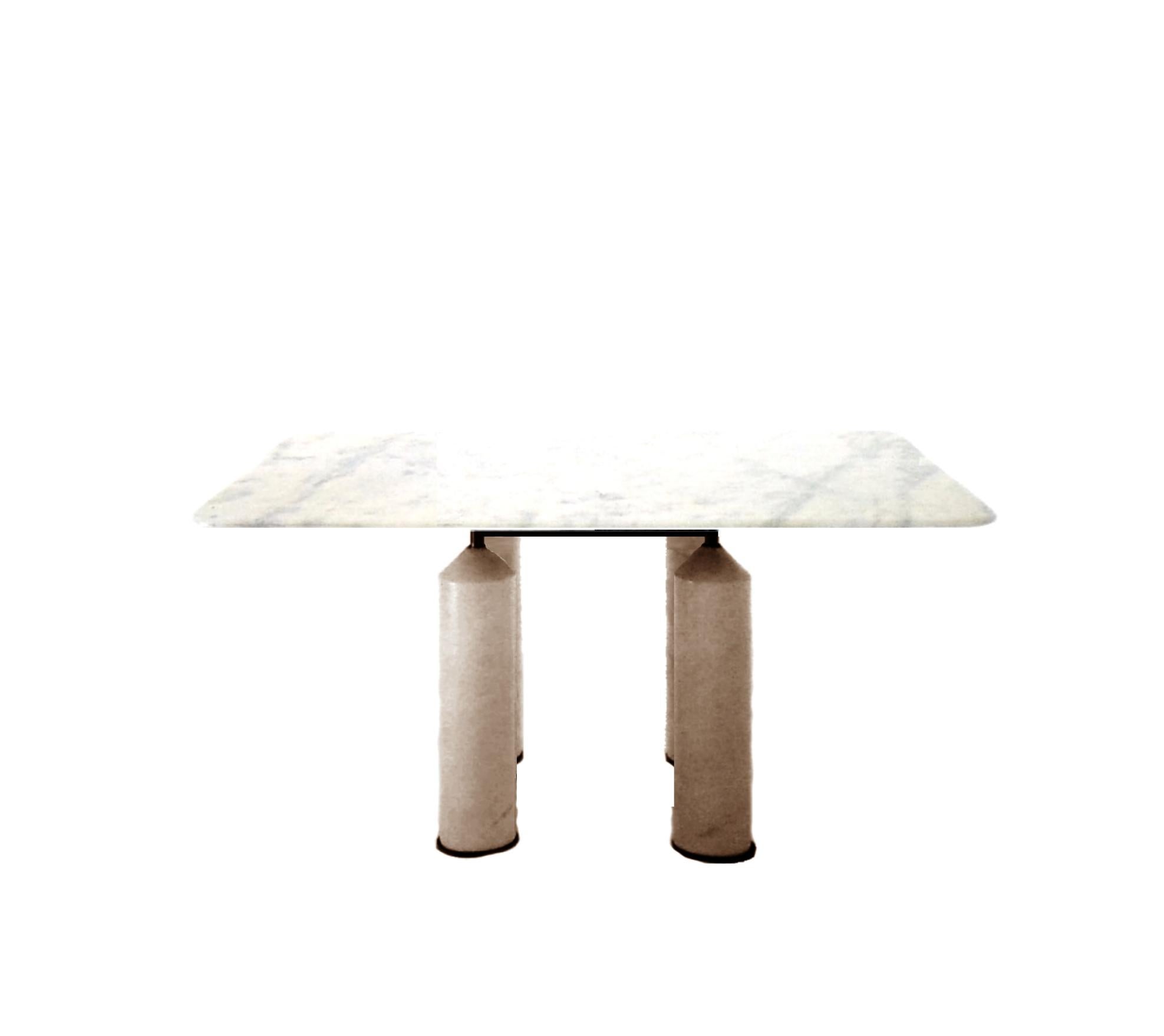 The tabletop of this square dining table (sits eight) is in white marble and the four legs are in travertine. The bearing structure is in gun-metal grey steel and makes the ensemble look lighter and the top almost suspended. 
The overall size is cm