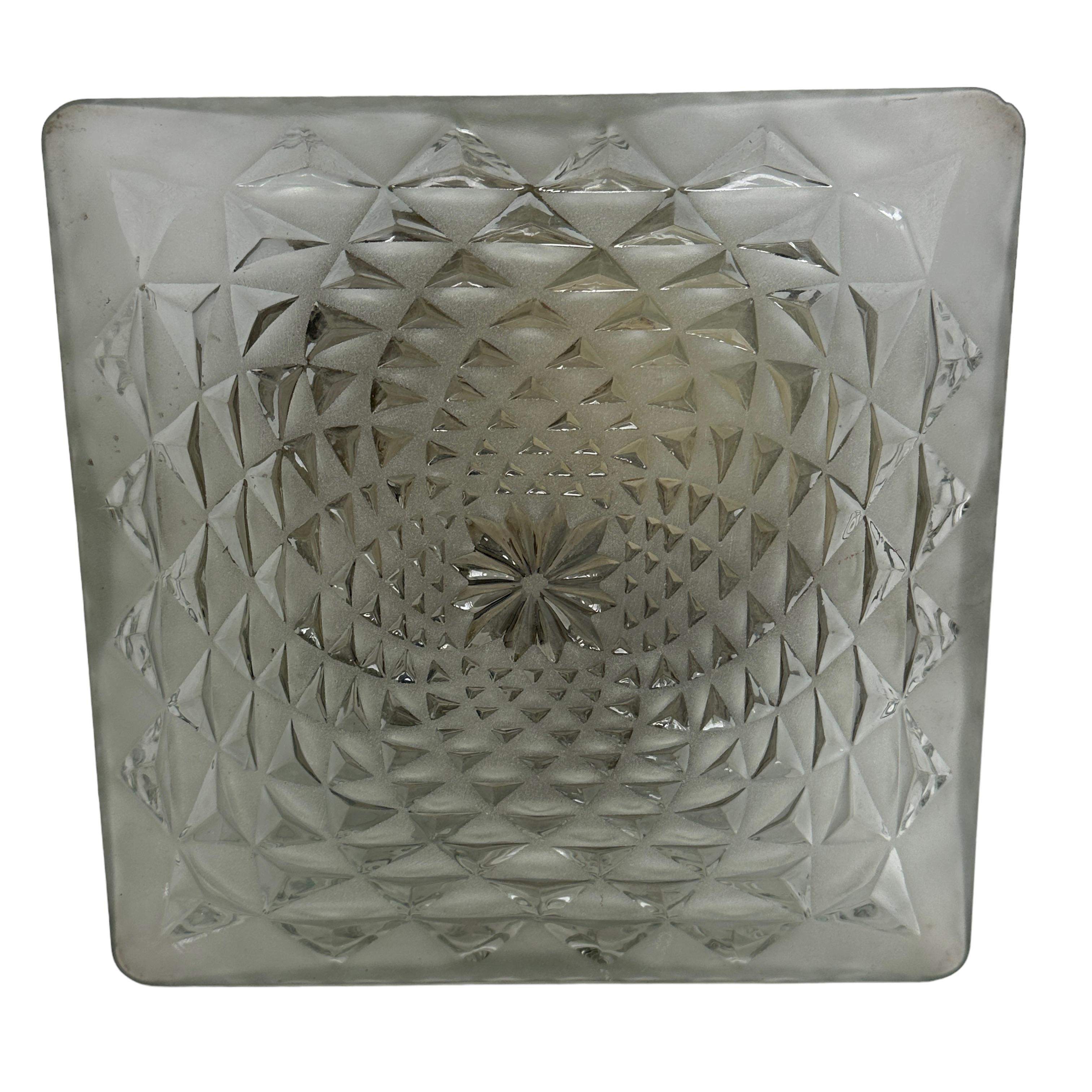 A beautiful flush mount by Honsel Leuchten, Germany. The glass is clear and features a star pattern with a frosted finish. The light is in very good, used condition and would make a great addition to any home. The fixture requires two European E27