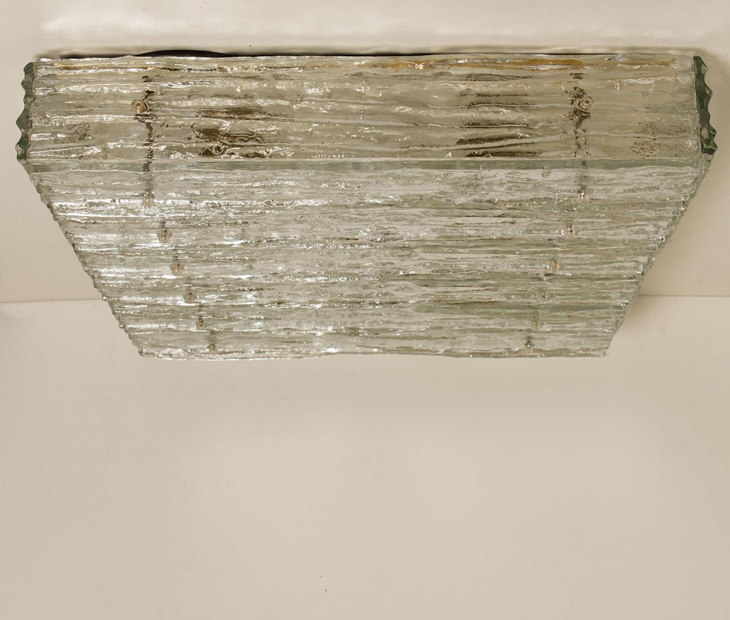 Clean lines to complement all decors. Amazing large scale square glass flush mount by J.T. Kalmar, Vienna, Austria, manufactured circa 1970, (late 1960s and early 1970s).

Multiple thick textured slabs of glass make up bottom and sides with clear