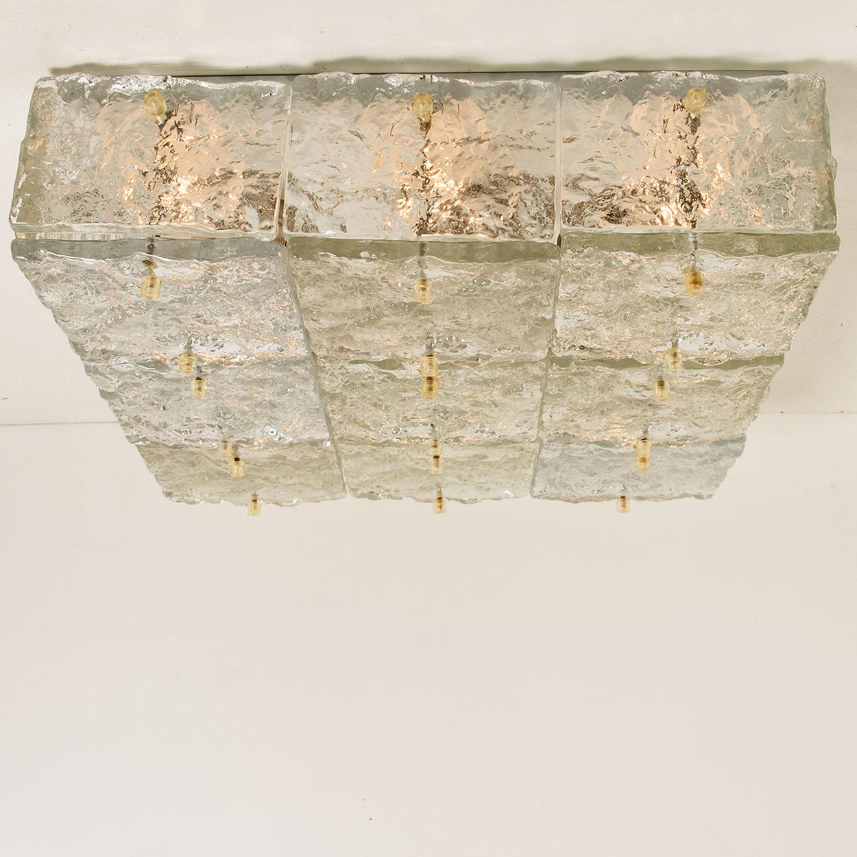 Clean lines to complement all decors. Amazing large scale square glass flushmount by J.T. Kalmar, Vienna, Austria, manufactured in circa 1970, (late 1960s and early 1970s).
Multiple thick textured slabs of glass make up bottom and sides with clear