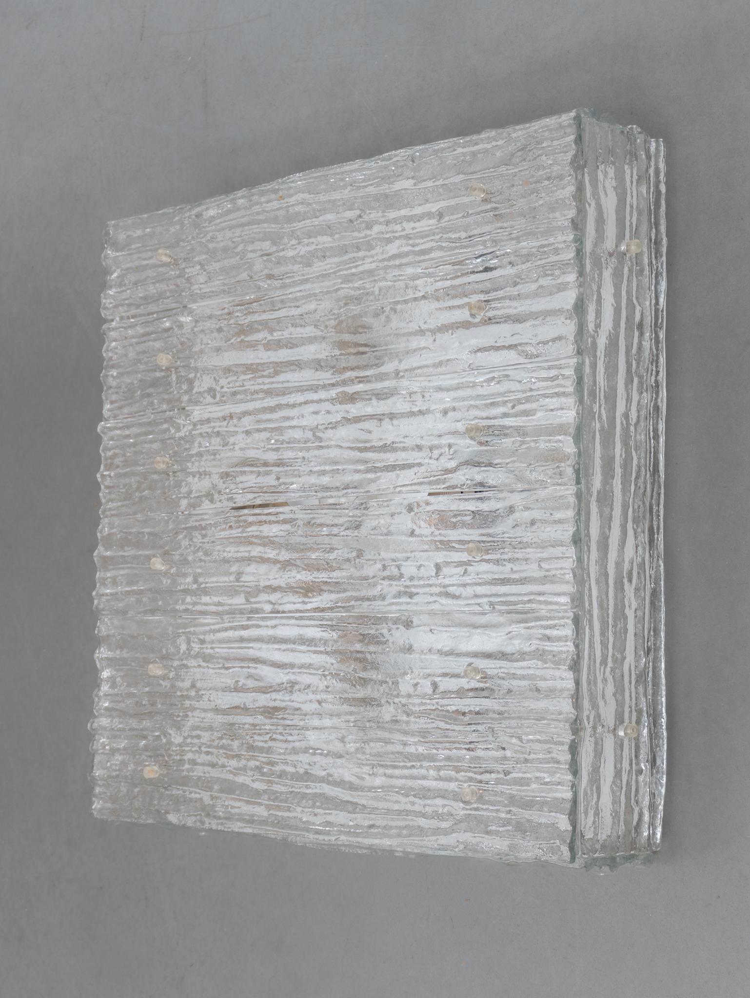 Large Flush Mount iced textured square glass by Kalmar, Austria 1960. Model Heidelberg. The flush mount has six iced textured glass panels at top and four panels beside all fixed to a white metal frame. Dimensions: Height: 13 cm-Width: 62 cm- Depth: