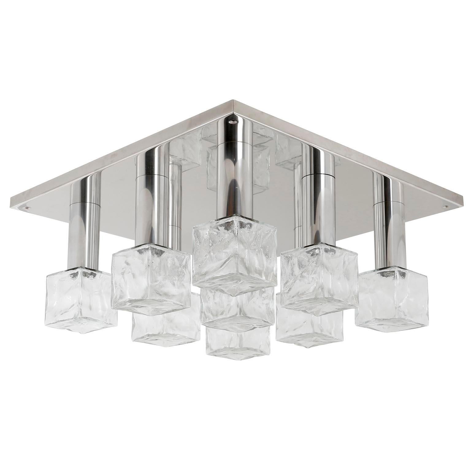 A large and square light fixture model 'Cubus' (German 'Würfel') by Kalmar, Austria, manufactured in midcentury, circa 1970 (late 1960s or early 1970s).
It is made of a polished stainless chromium steel (similar to chrome) backplate and frosted