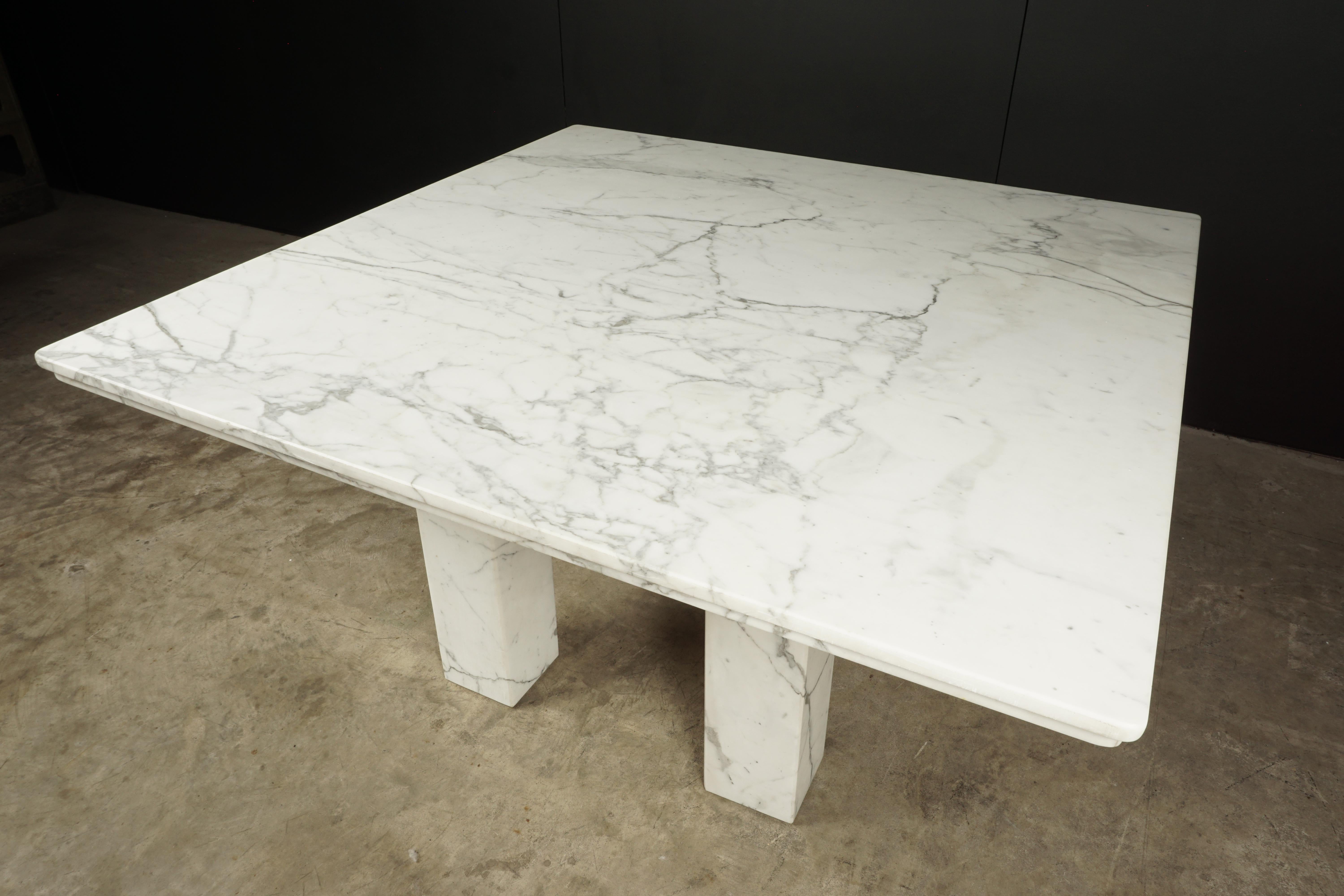 Large square marble dining table from France, circa 1960. Solid marble top and legs with light wear and use.