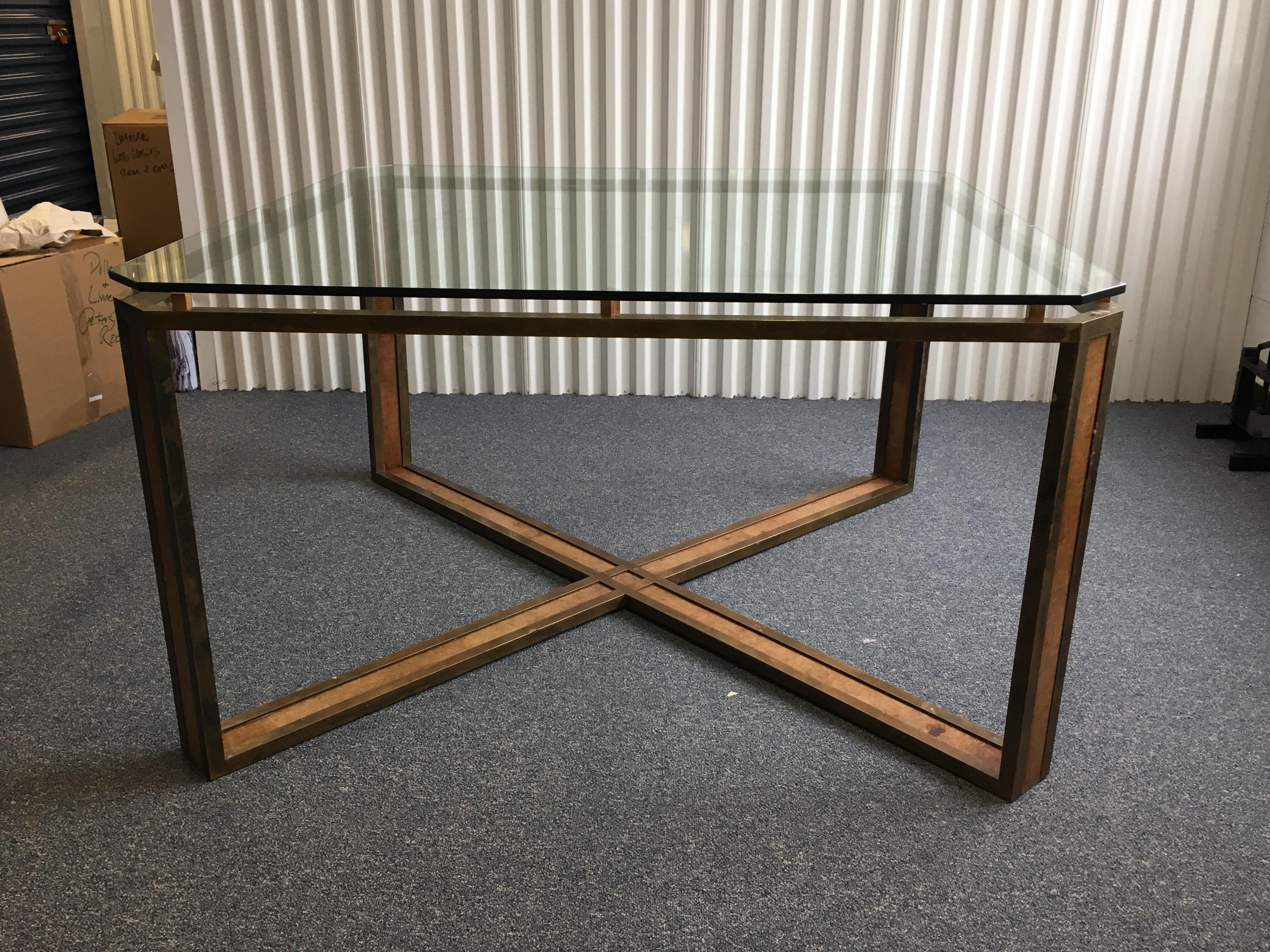 Large square Midcentury X-base brass and leather table with glass top. Brass frame with inlaid leather. Leather wrapped squares hold glass top. Great looking piece. Glass has some scratches, leather is faded and brass has aged. Structurally sound.