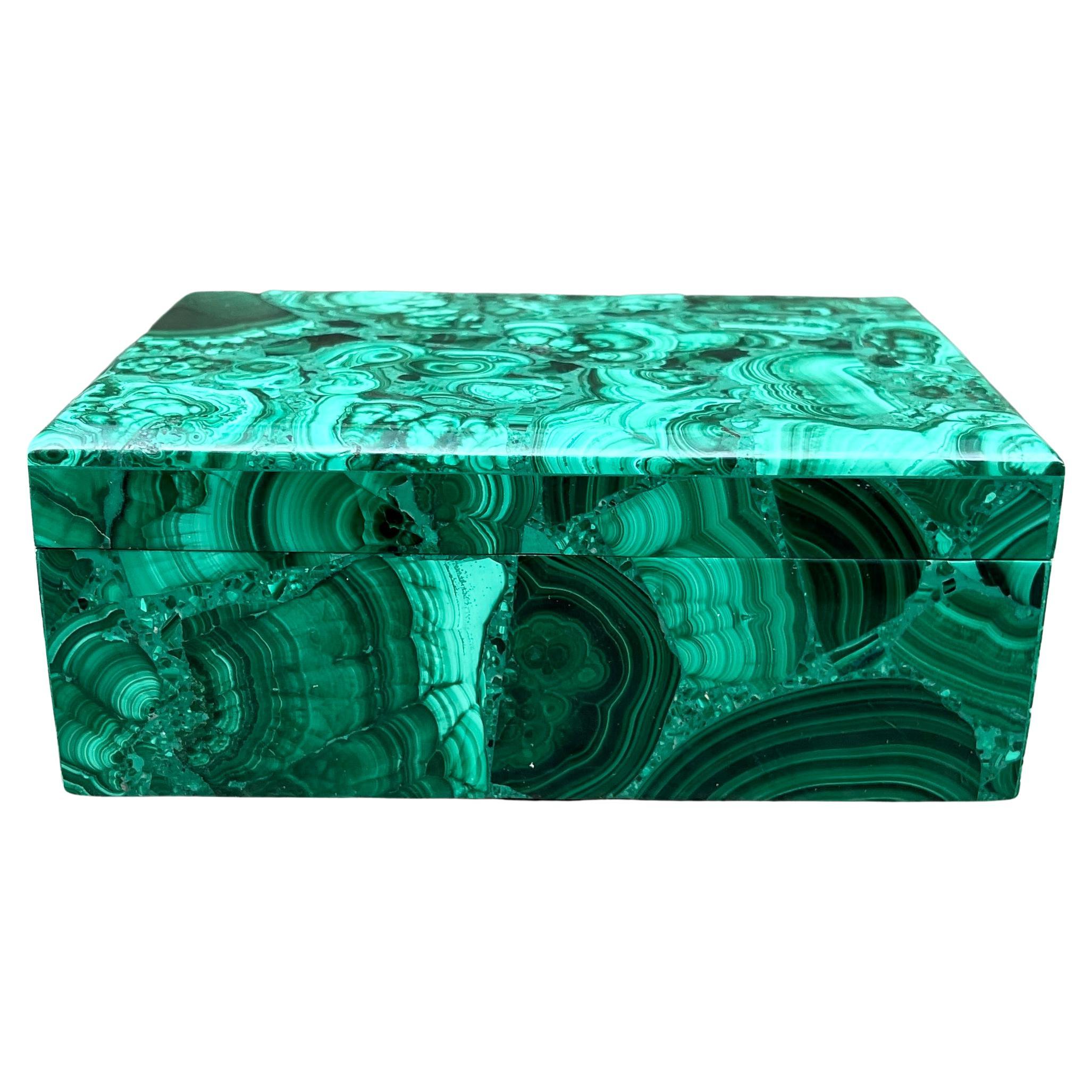 Large Malachite Jewelry or Vanity Box. Malachite is a green copper carbonate mineral. It is part of the monolithic crystal system and has a silky luster. The malachite for this box was sourced from the Congo, where the finest quality of this mineral