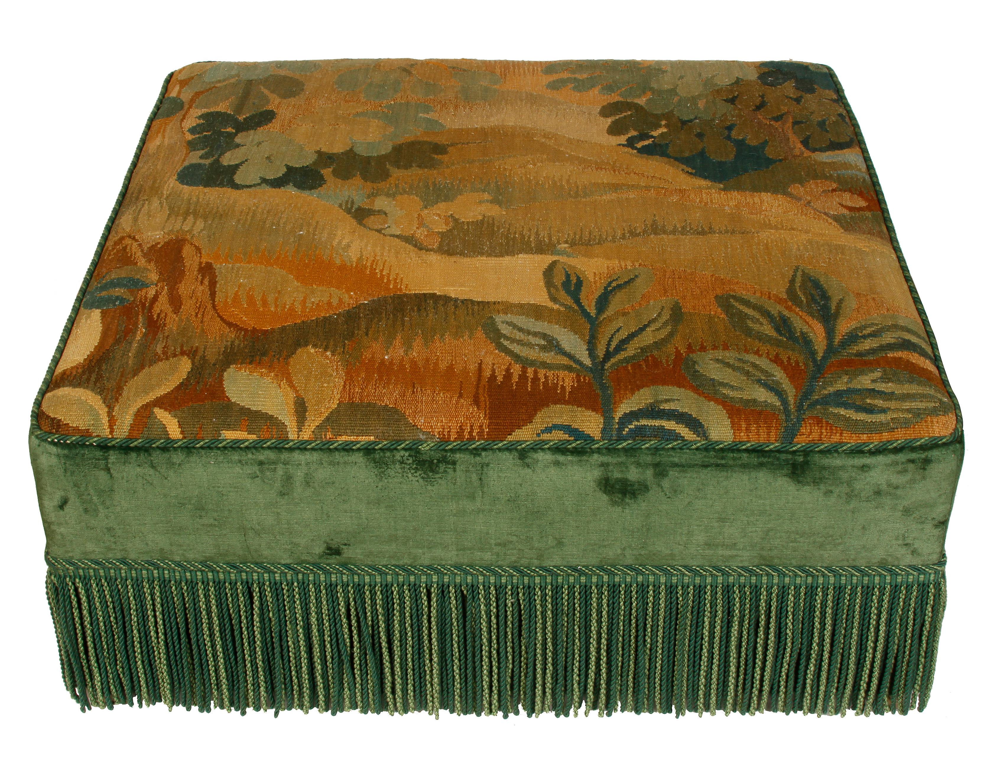 Large square ottoman with multicolored tapestry seat and green velvet sides with green bullion fringe. Hidden casters move nicely.