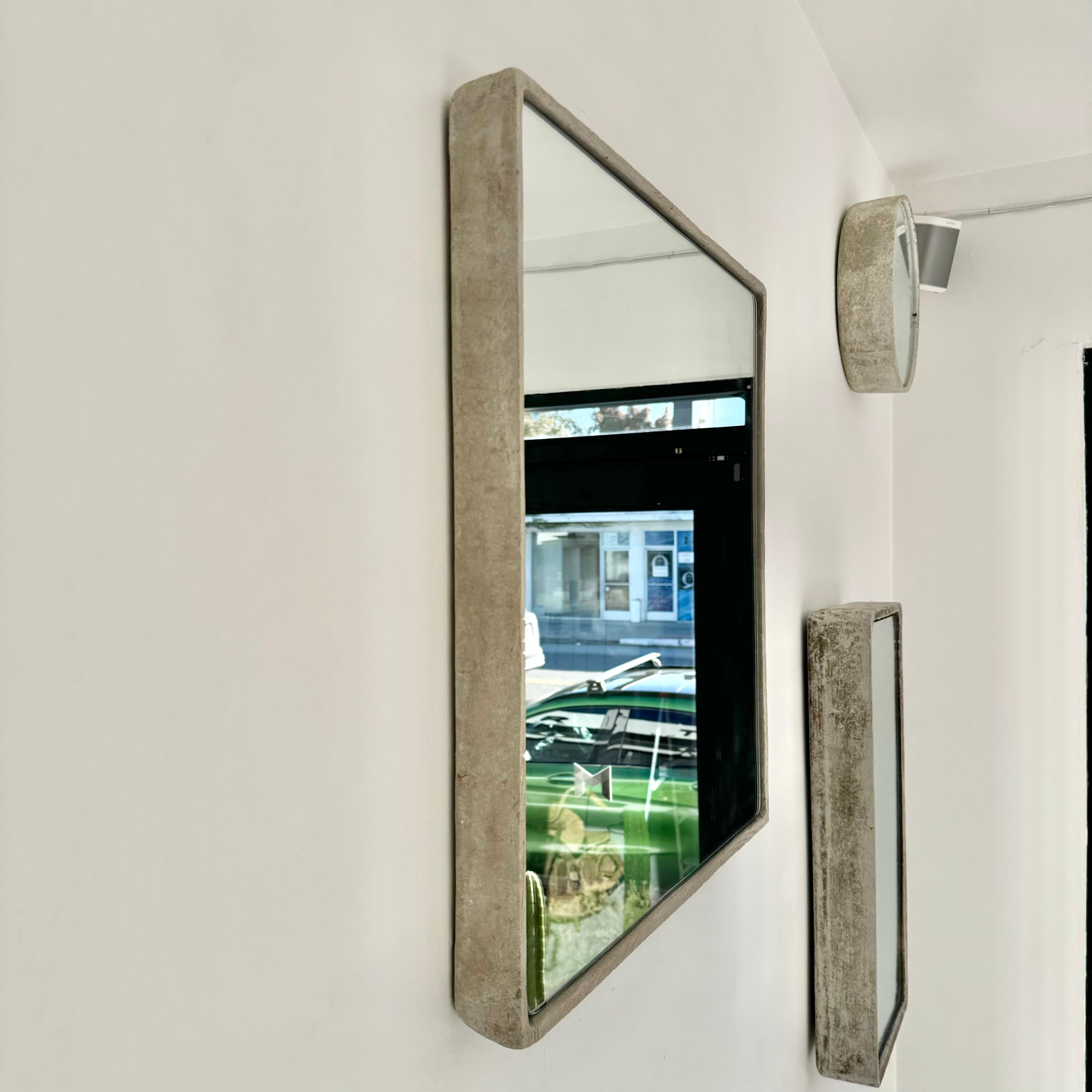 Monumental shallow square Willy Guhl concrete mirror. Substantial concrete vessel originally produced at the Eternit factory in Switzerland in the 1960’s. Custom mirror/glass was professionally hand cut and added recently. Beautiful light patina