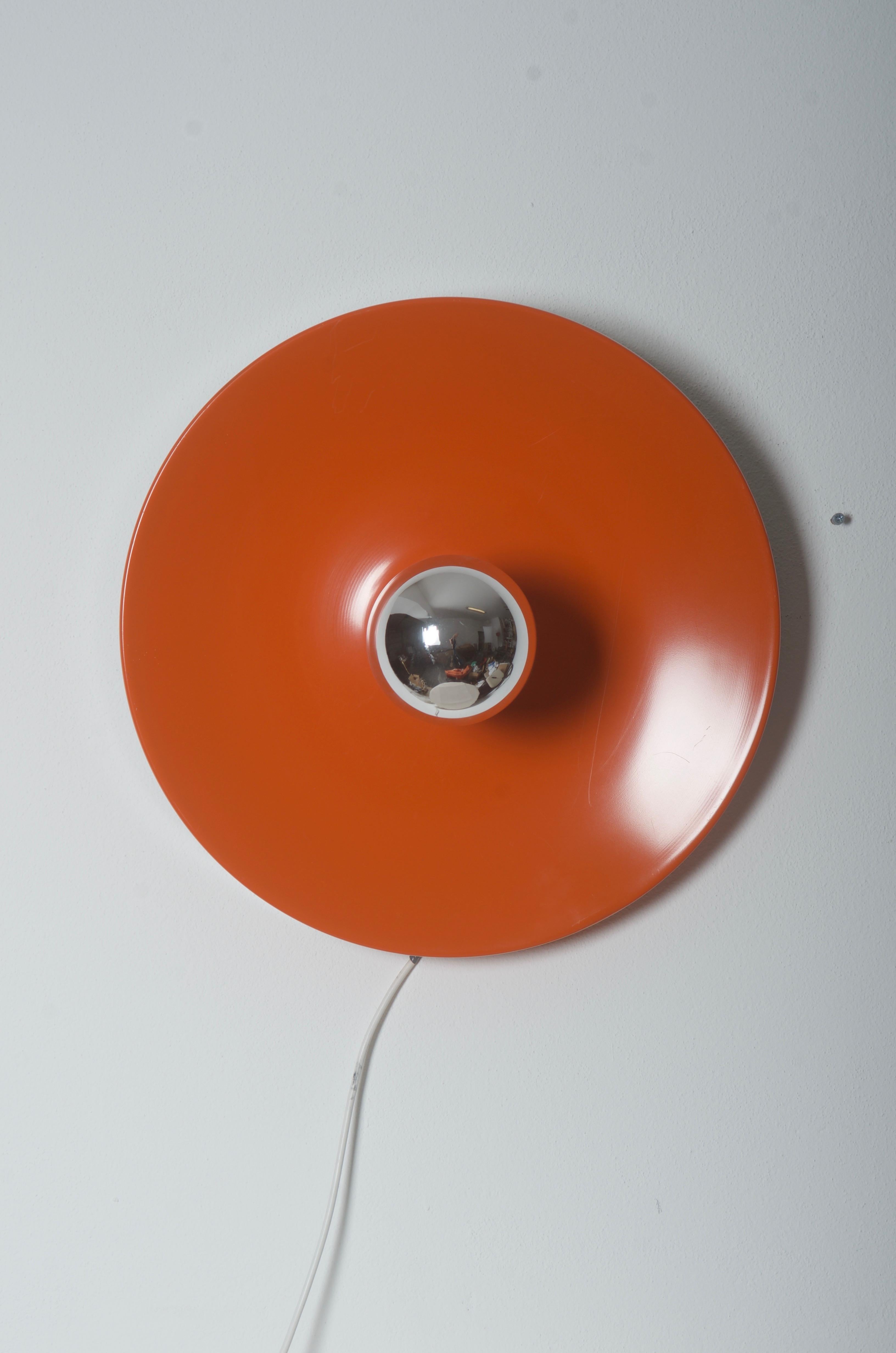 Ceiling or wall light, German design in the 1970s. Construction made of orange lacquered steel.