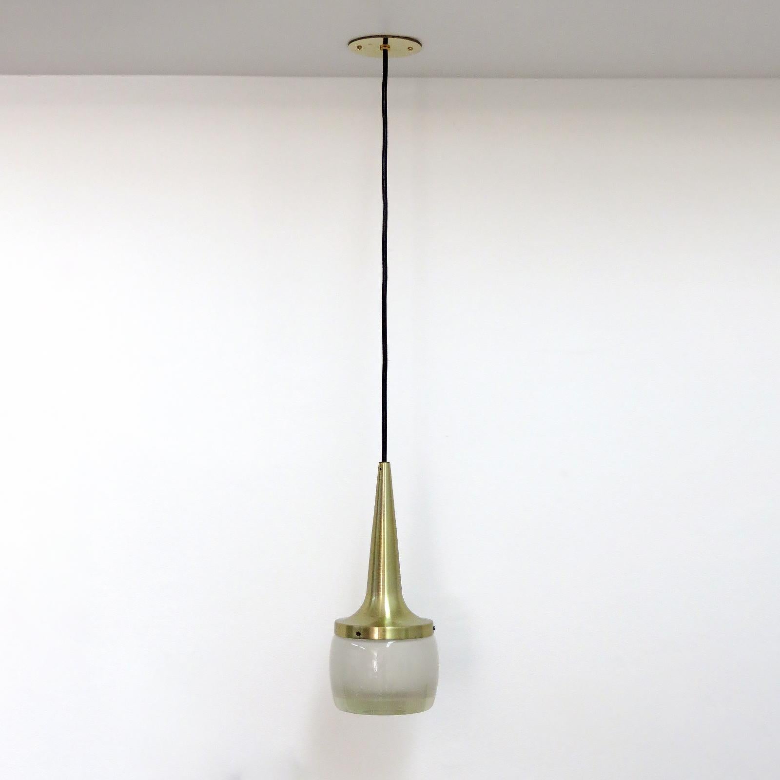 Stunning pendant lights by Staff Leuchten, Germany, brushed brass colored aluminum and heavy molded glass, etched on the inside, with custom solid brass canopy. Wired for US standards, one E26 socket per pendant, max. wattage 60w each or LED