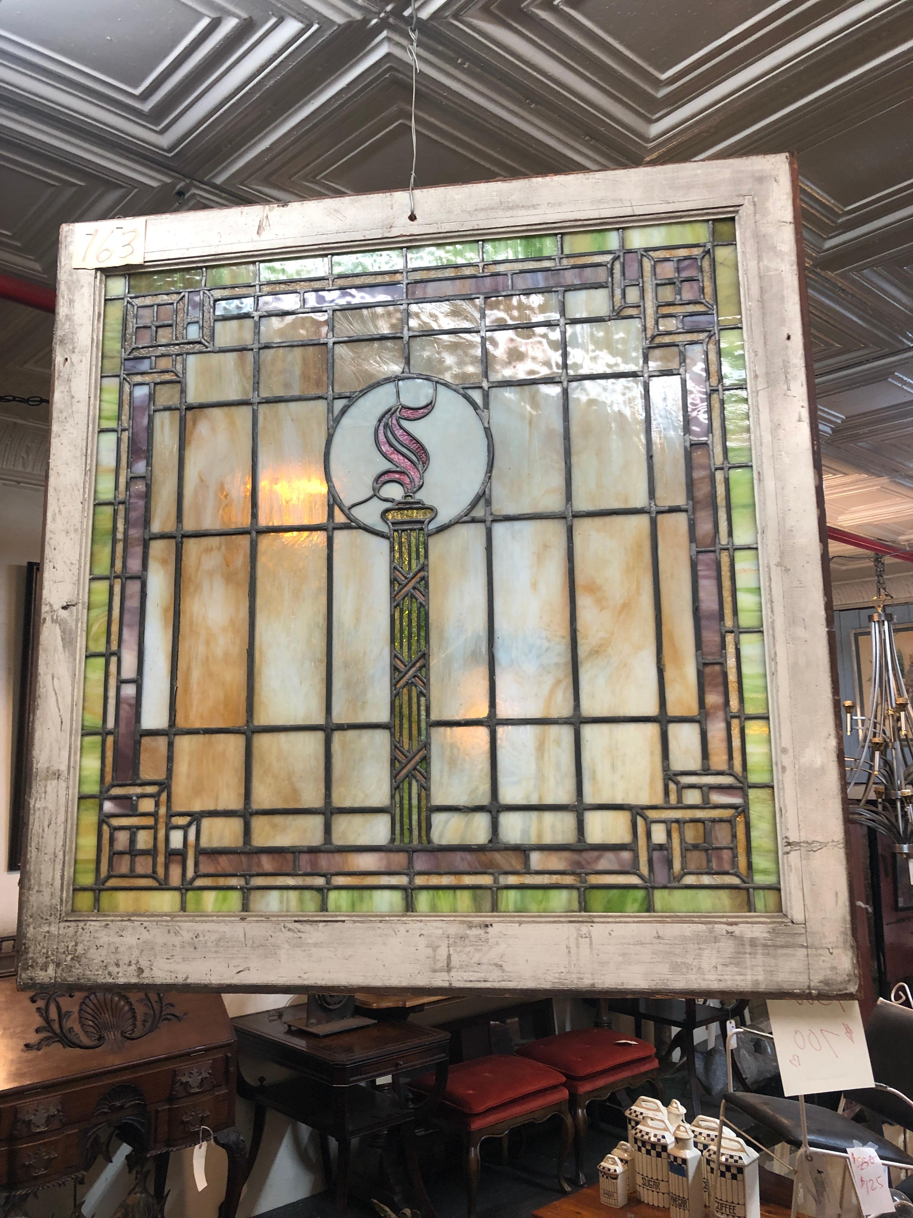 Large American made stained glass window with torch and 'S' flame. Beautiful coloring and lead work.
2 available, listing is for 1.
Currently housed in a temporary wooden frame - the overall dimensions are for the stained glass and the