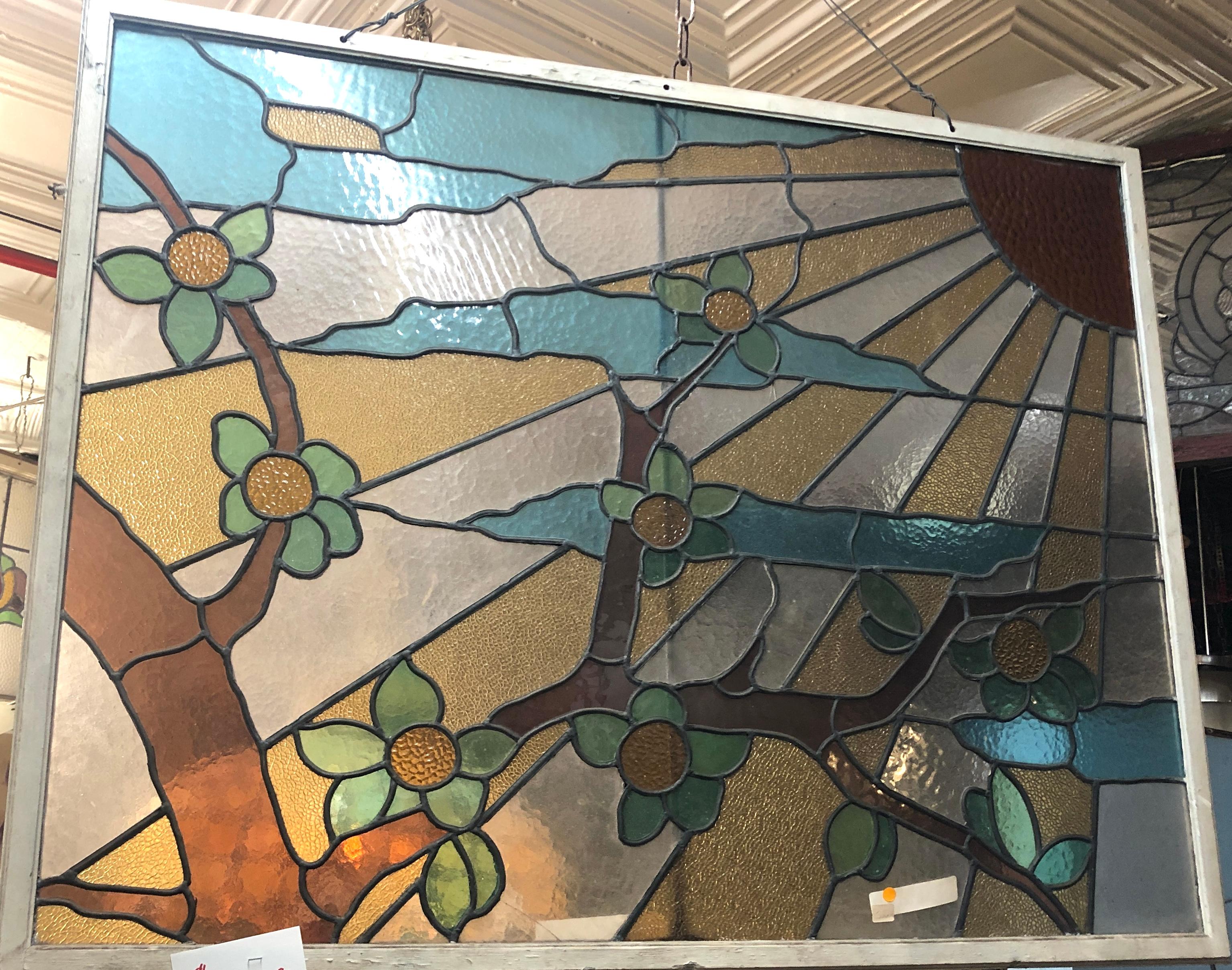 Large glass window with stained glass design. Sun rays coming down on an orange tree. Produces great light.
Currently housed in a temporary wooden frame - the overall dimensions are for the stained glass and the frame.
Located in NY
