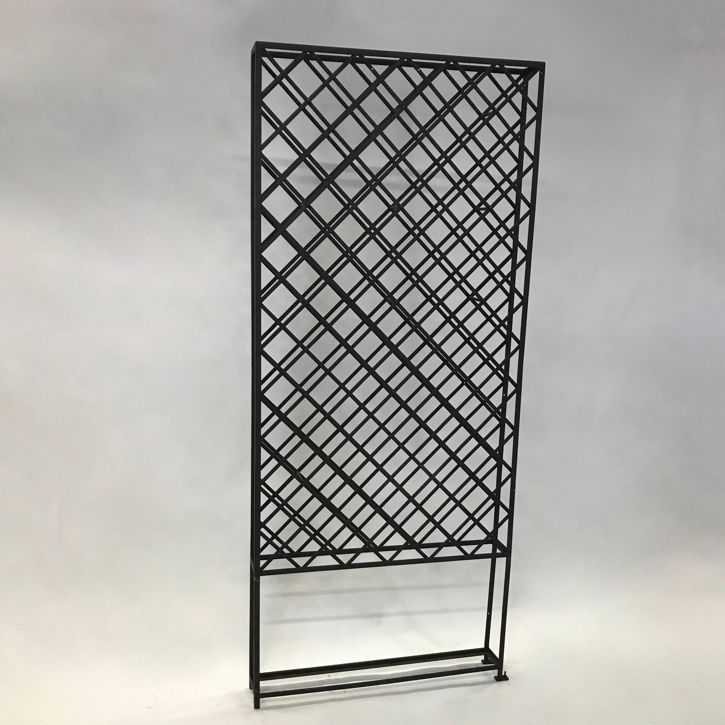 Tall, impressive, latticed wrought iron, standing wine racks can hold up to 50 bottles each. Two racks are available. The racks must be braced for stability.