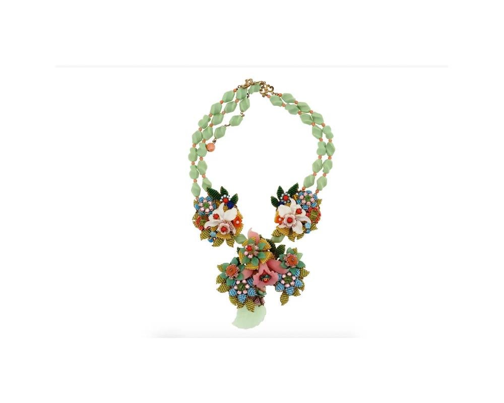 A large vintage beaded necklace with golden fittings by Stangley Hagler, an American costume jewelry brand. Designed in the 1990s by Ian St. Gielar who worked for Stanley Hagler as his craftsman. Two strands of pistacchio green and pink beads are