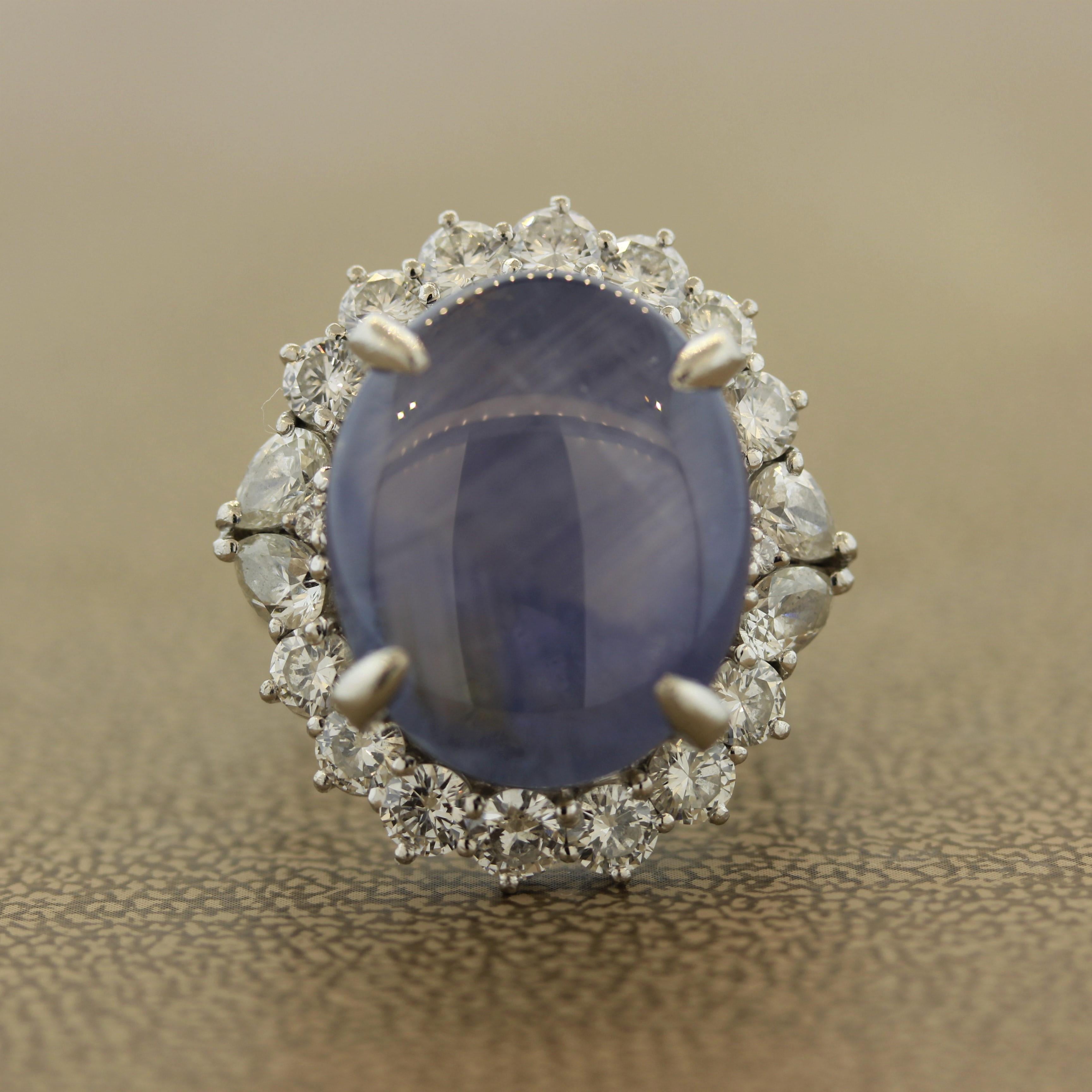 An eye popping 27.36 carat natural star sapphire is proudly set atop this platinum ring. The sapphire cabochon actually shows up to 3 individual stars when a light is shined on it. This is a rare phenomenon that is rarely seen. It is accented and