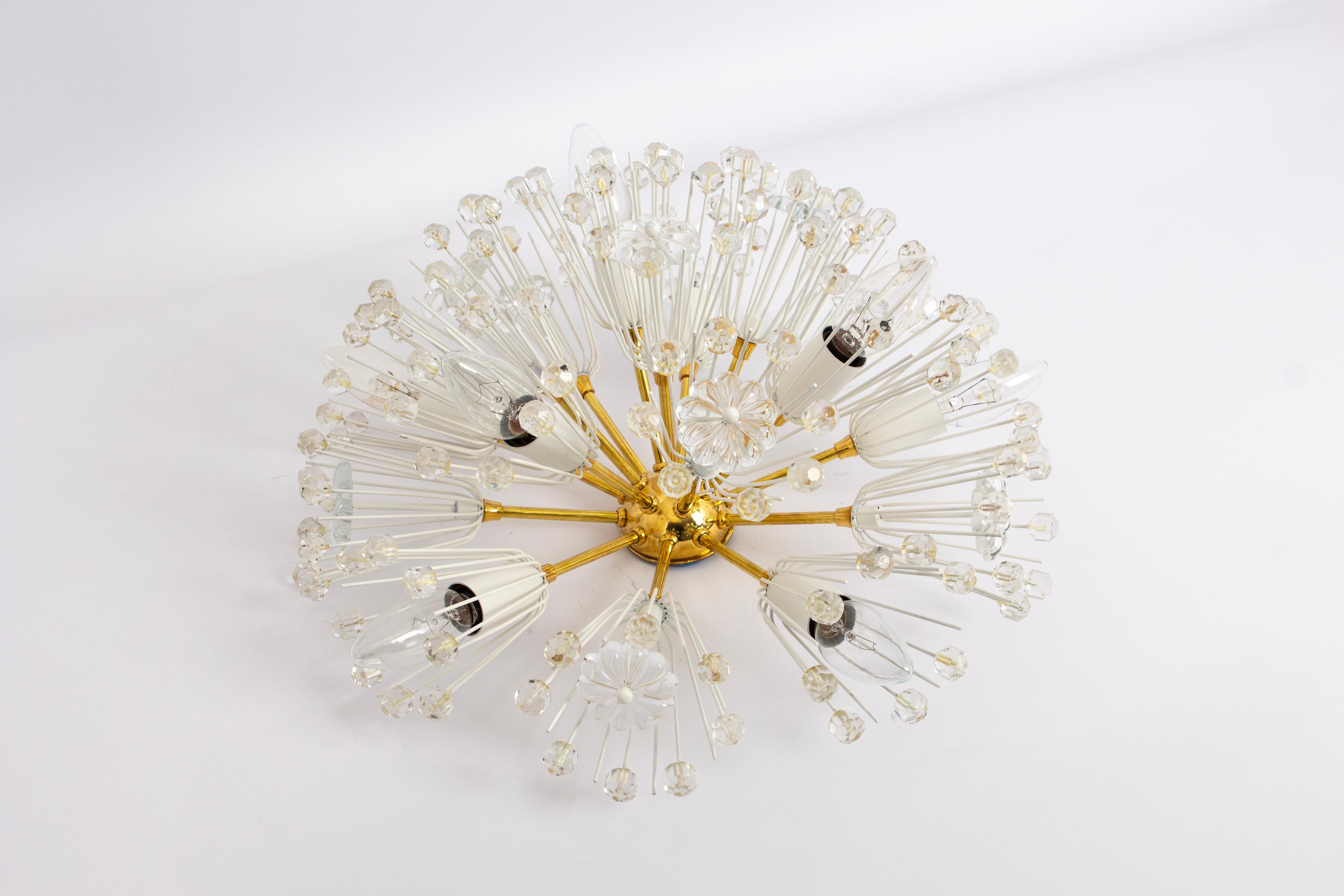 Beautiful starburst brass flush mount with many of crystals designed by Emil Stejnar for Nikoll, manufactured in Austria, circa the 1960s.

Heavy quality and in good condition with small signs of age.
Cleaned, well-wired, and ready to use. The