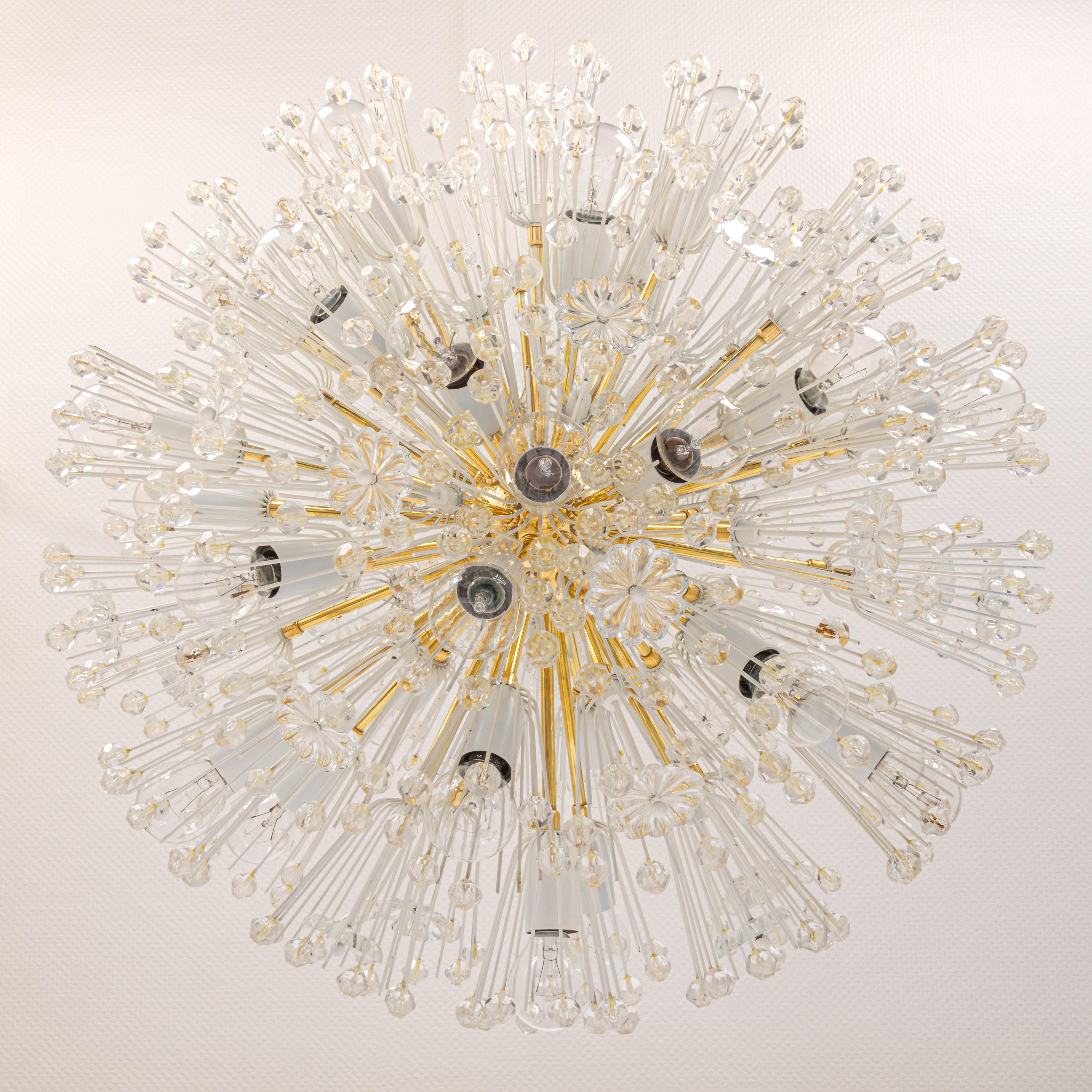 Beautiful large starburst brass chandelier with hundreds of crystals designed by Emil Stejnar for Nikoll, manufactured in Austria, circa 1960s.

Heavy quality and in good condition with small signs of age. Cleaned, well-wired and ready to use. The