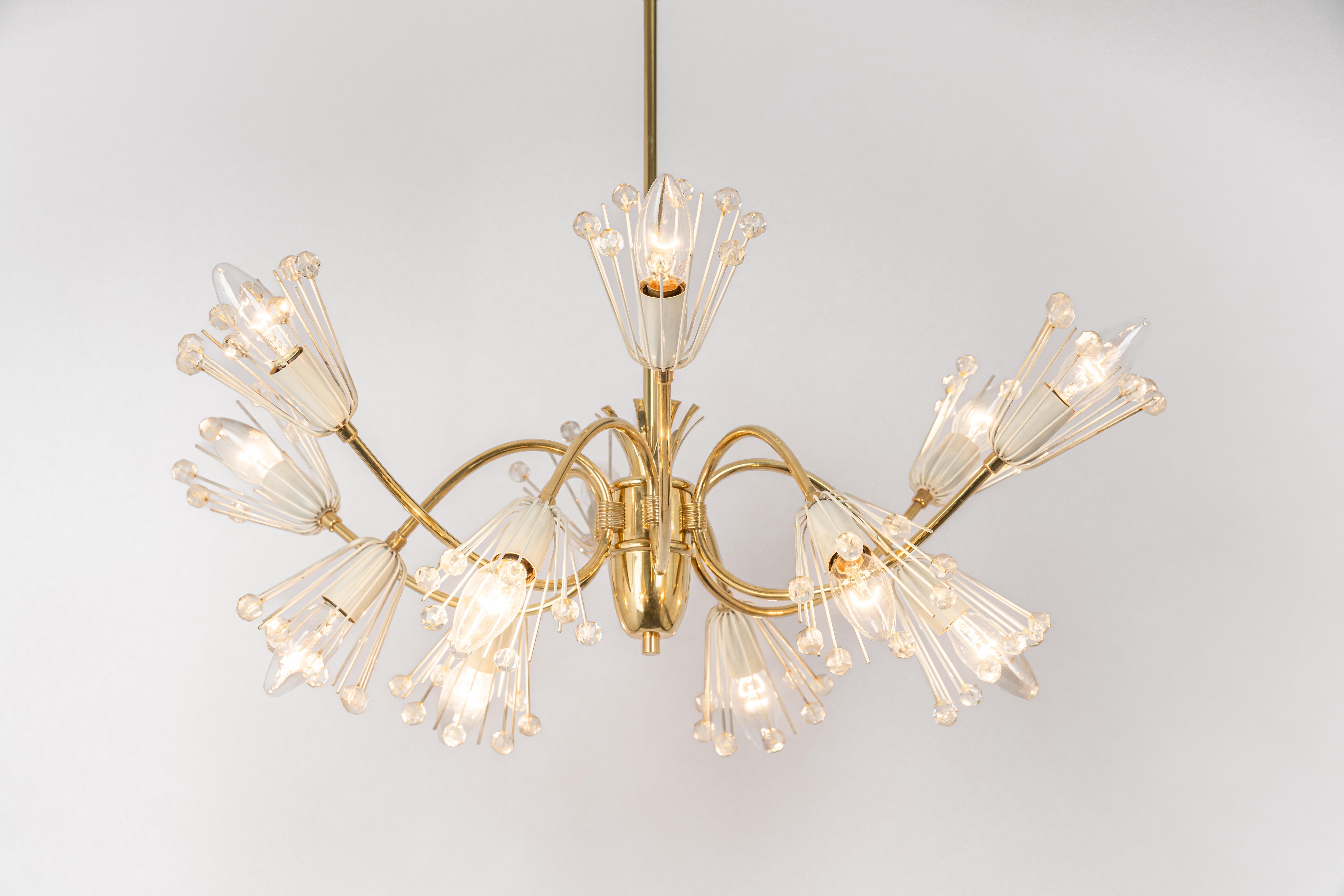 Beautiful large starburst brass chandelier with hundreds of crystals designed by Emil Stejnar for Nikoll, manufactured in Austria, circa 1960s.

Heavy quality and in good condition with small signs of age. Cleaned, well-wired and ready to use. The