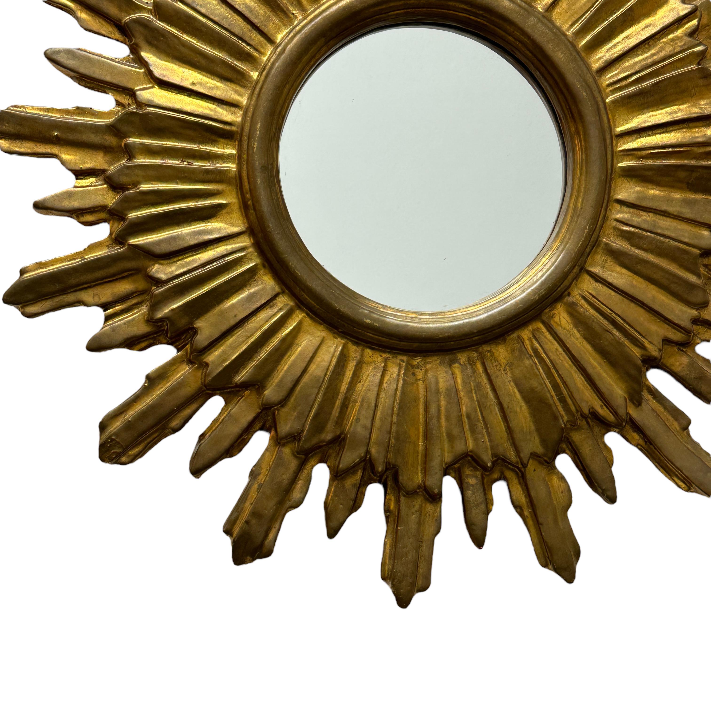 A gorgeous starburst sunburst mirror. Made of gilded wood and stucco. It measures approximate: 19.5