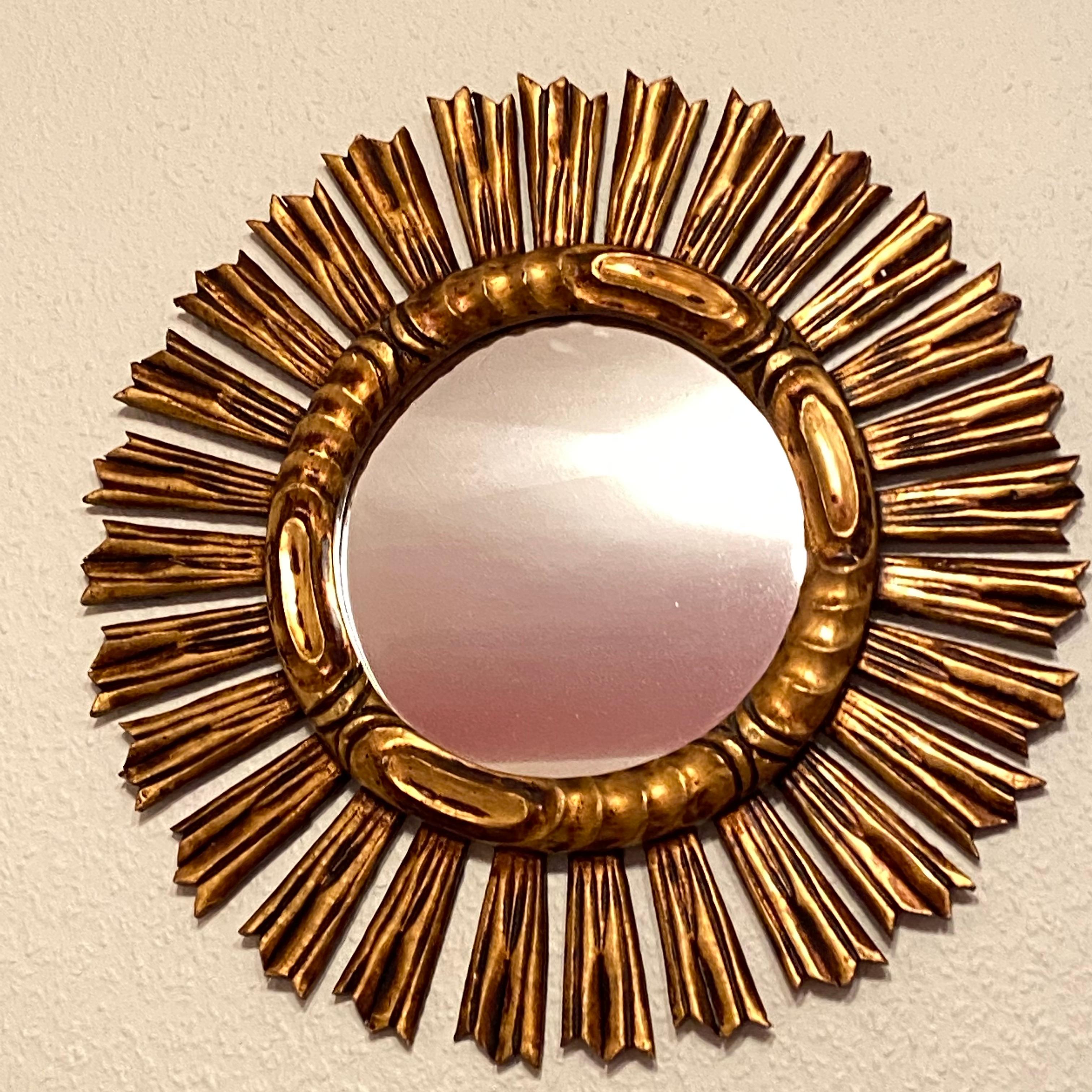 A gorgeous starburst sunburst mirror. Made of gilded wood. It measures approximate: 20