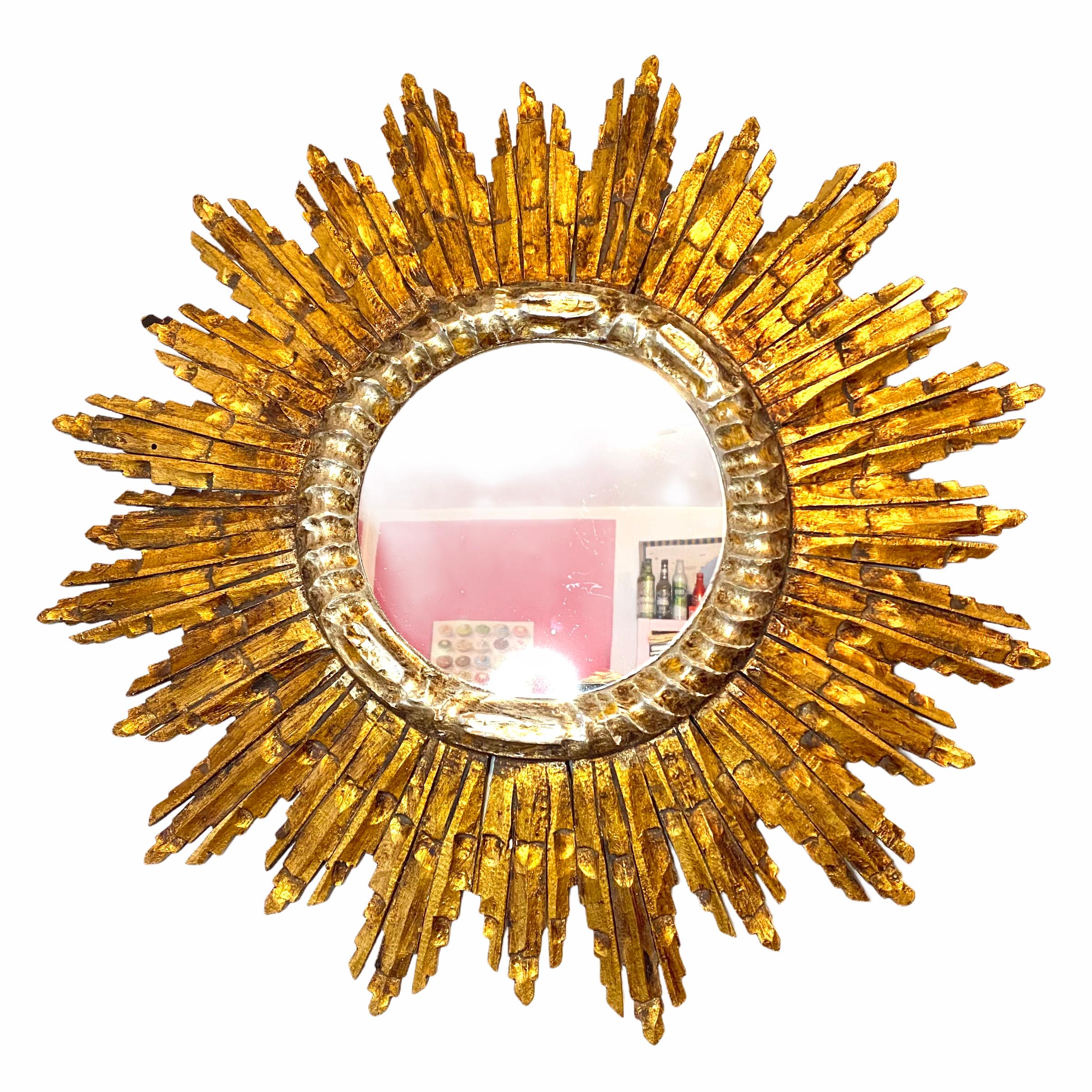 A gorgeous starburst sunburst mirror. Made of gilded wood. It measures approximate: 25