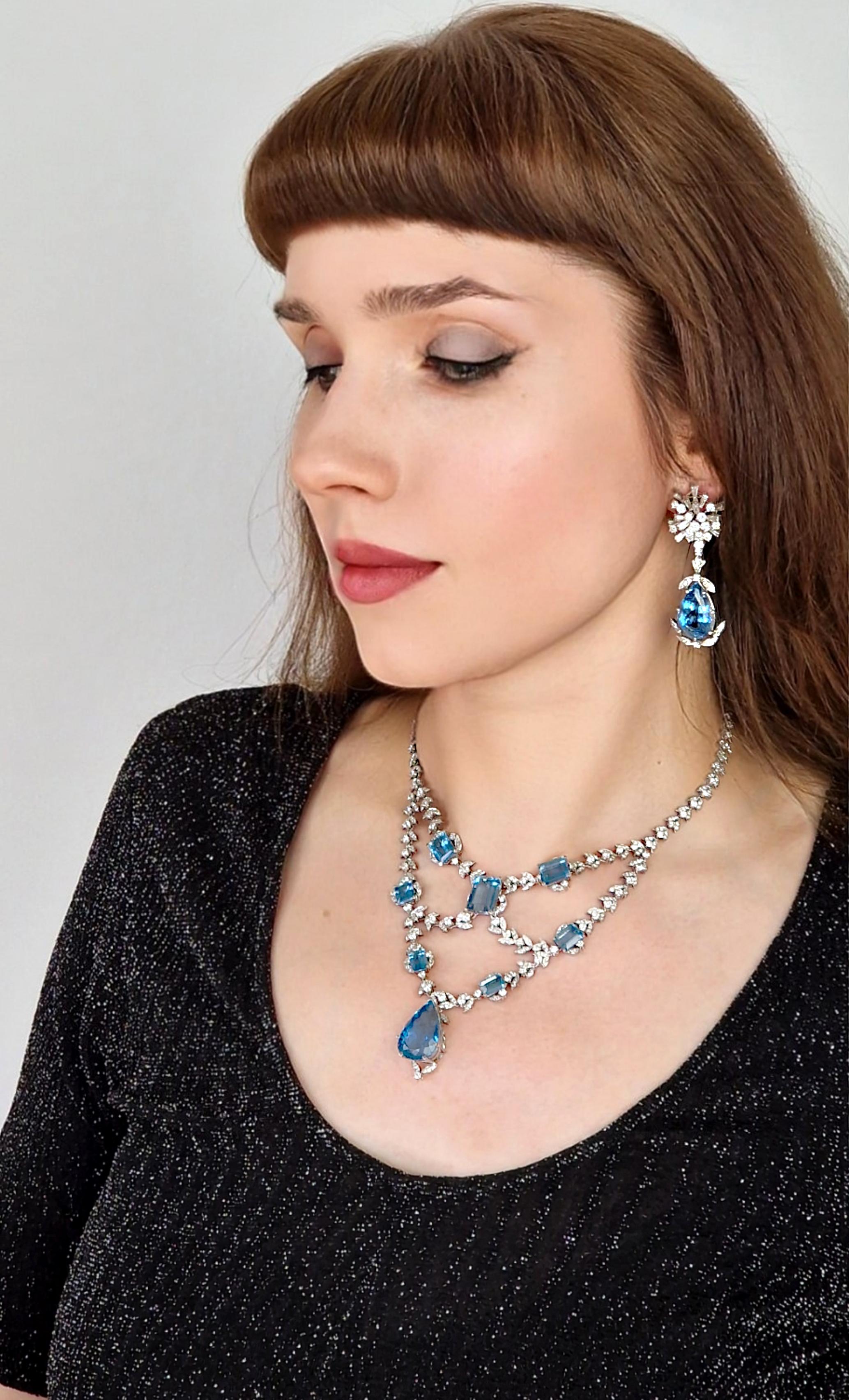 A classic and absolutely stunning piece, this is a one-of-a-kind necklace features immaculately matched dark blue emerald cut aquamarines mounted on delicate swallow wing motifs set with fine white brilliant diamonds.  

This stunning necklace
