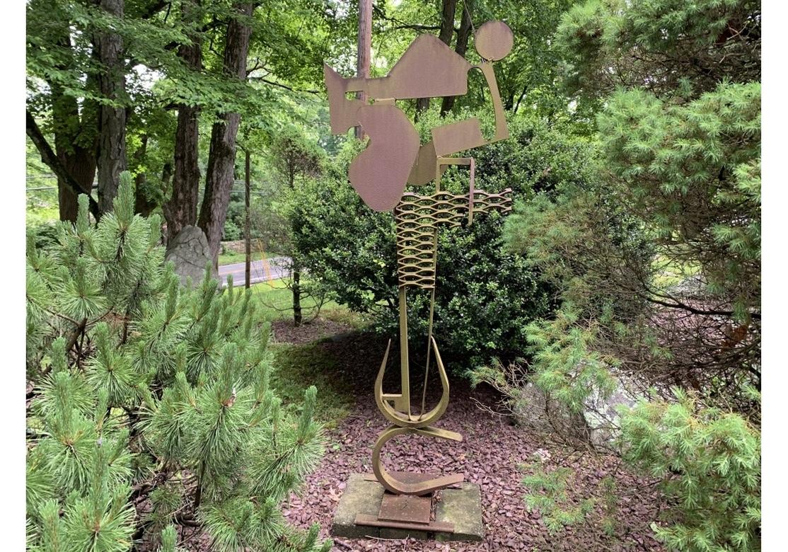 A large mid century style steel abstract by multidisciplinary artist Norma B. Flanagan. Signed along the lower curve at the base. A tall steel piece, originally painted, now worn bare to an Industrial rust patina. With a group of varied angular