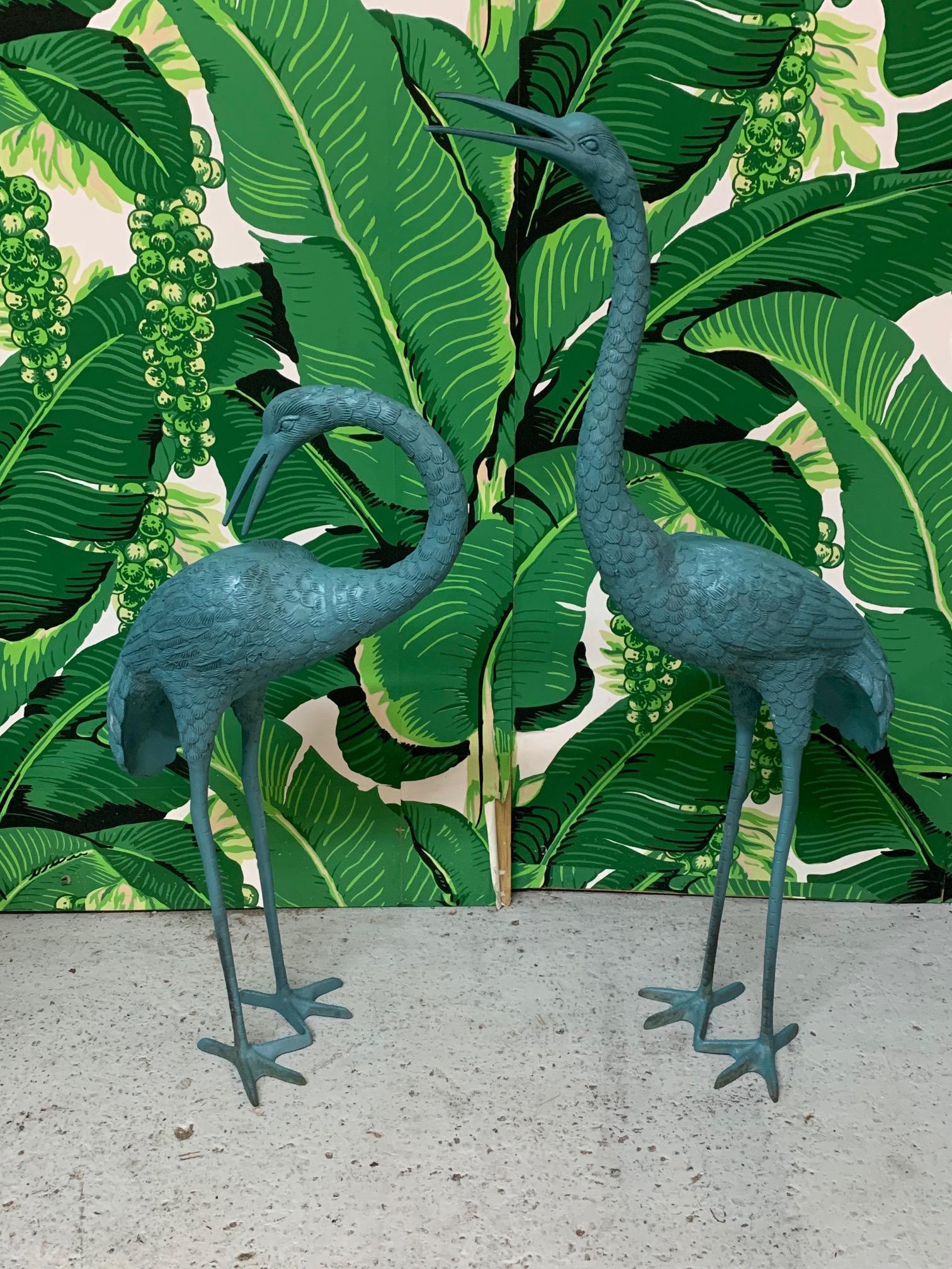 Pair of heavy large metal heron/crane/egret statues finished in light blue, a perfect compliment for your indoor or outdoor decor. Good condition with minor imperfections consistent with age, see photos for condition details. Large bird measures 6