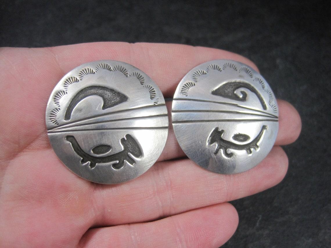 These gorgeous vintage Native American earrings are sterling silver.

Measurements: 1 3/8 inches
Weight: 18.5 grams

Marks: Sterling, Picto Star
This hallmark may belong to Dorothy Martinez. The darkened textured symbols looks to be her